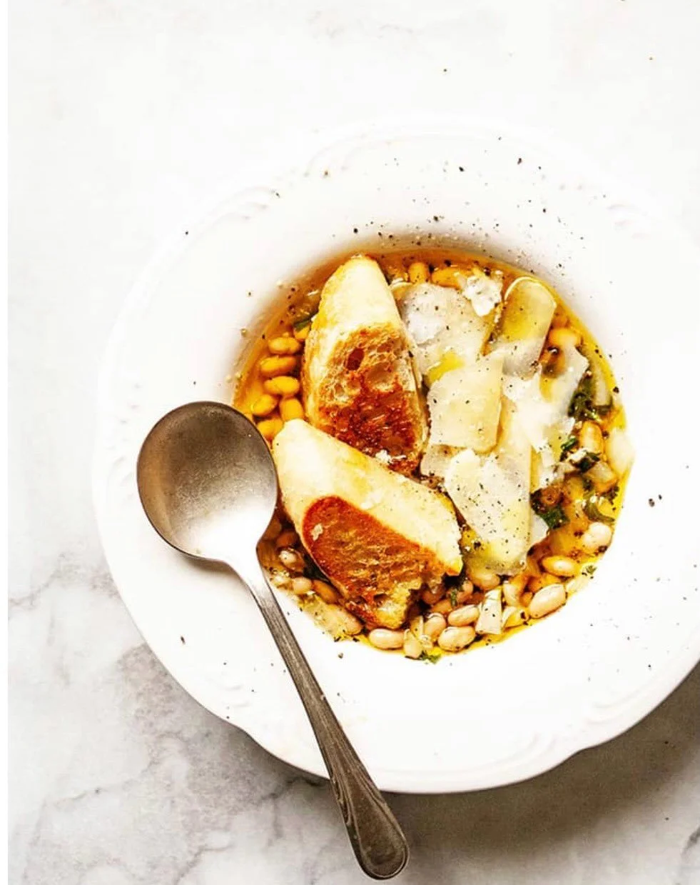 BEAUTIFUL FOOD BY DESIGN | Behold the humble bowl of beans, warming comfort in the late winter chill. Italian White Beans creamy and garlic infused create a master recipe &ndash; versatile, flexible, easily transformed into a variety of dishes &ndash