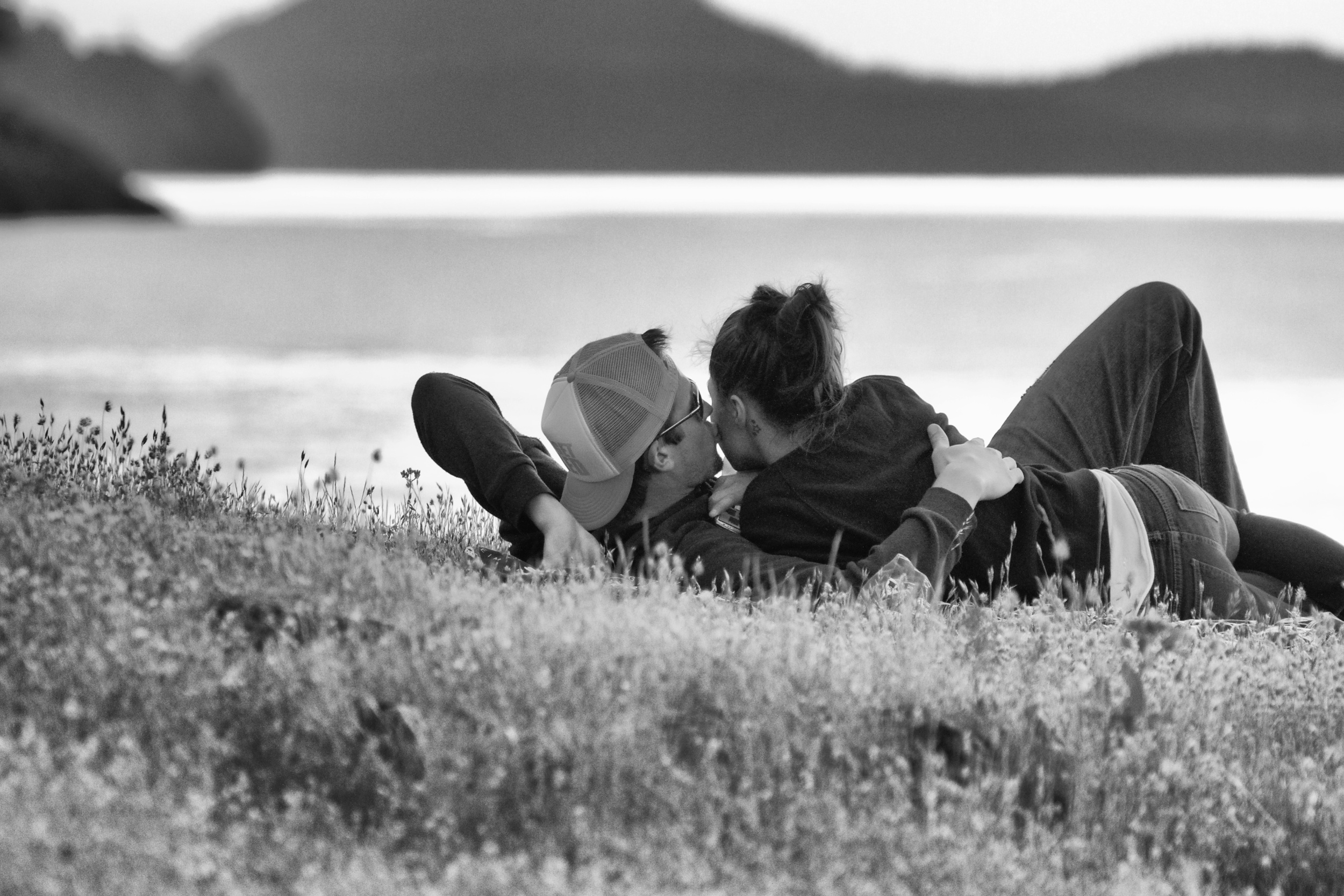  Young lovers share kiss in the sunset.&nbsp; Canon EOS 7D EF 70-300mm at 207mm f/5.6 1/250 ISO 3200 