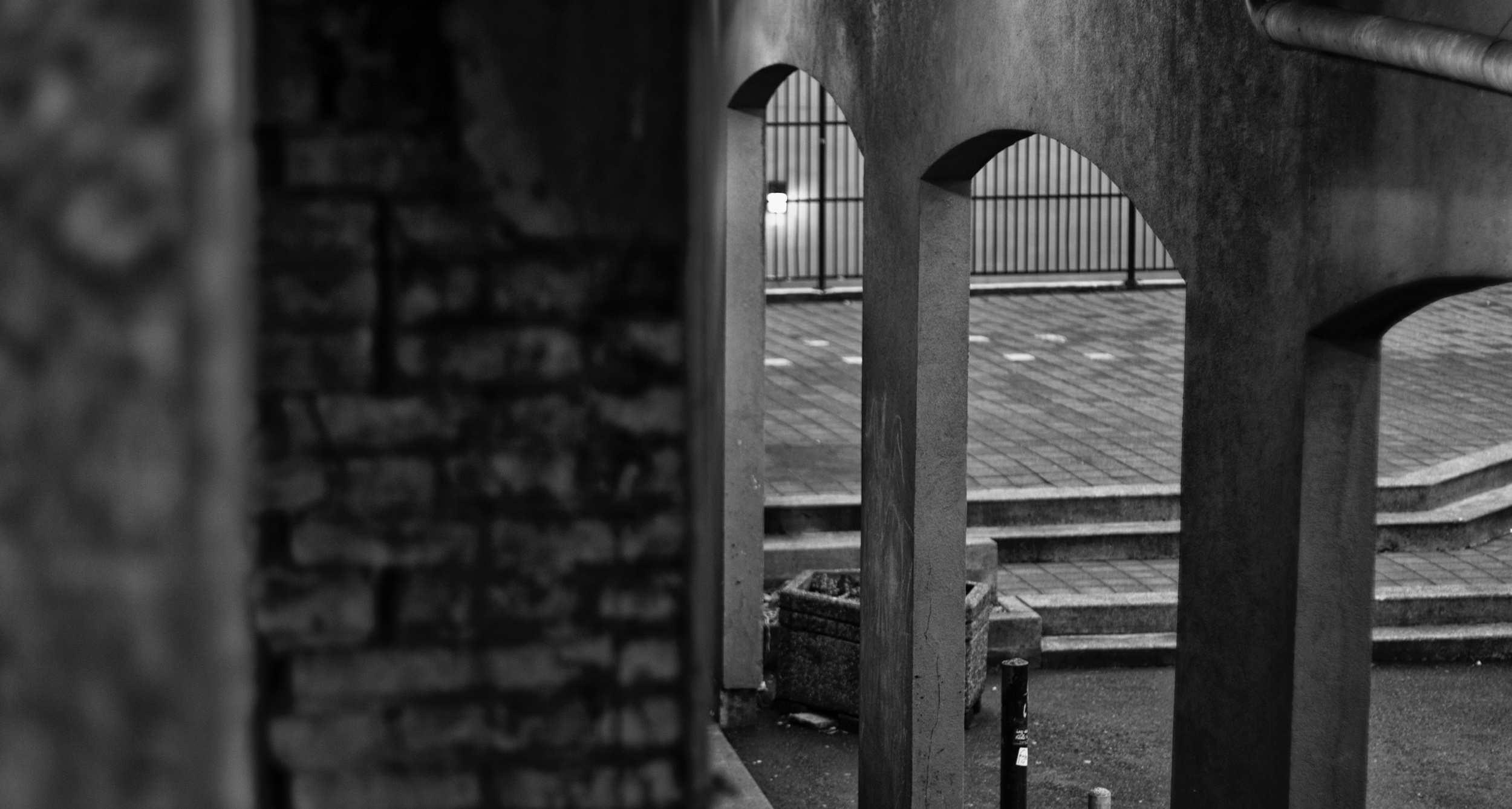 Looking down into the pillared entry of a courtyard. Canon EOS 7D Mk. II EF 50mm f/1.4 at f/1.6 1/80 ISO 250