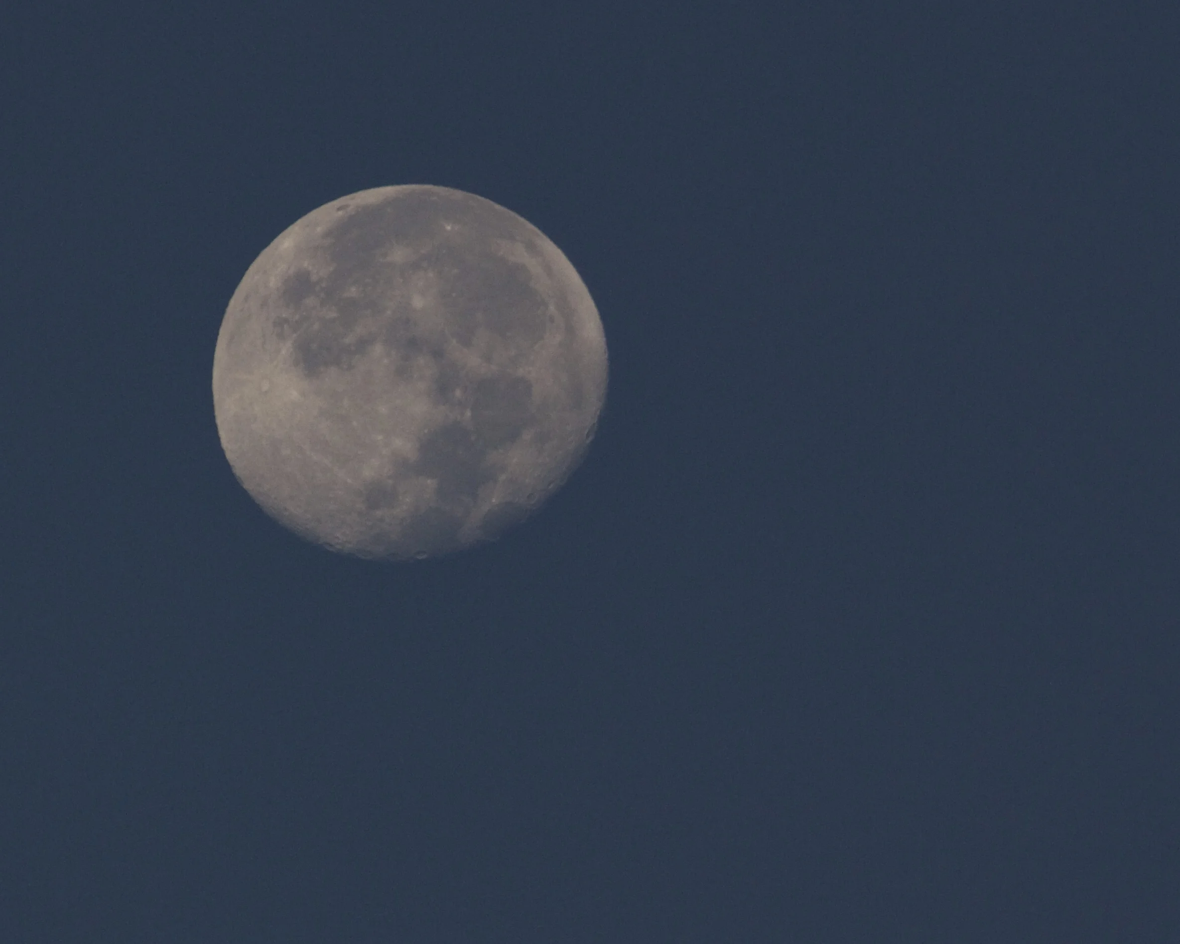 A nearly full moon rises long before sunset and sets after sunrise. Tides have been higher than normal. 