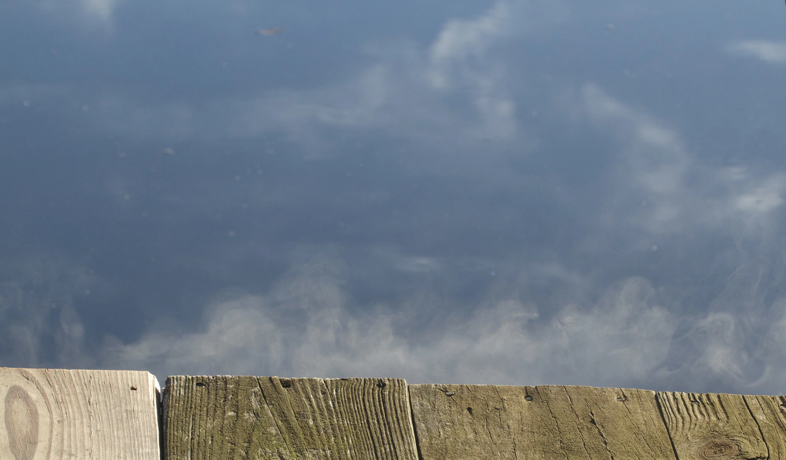 Smoke like fog swirls on the water while the dock seems to smolder from the evaporating frost.