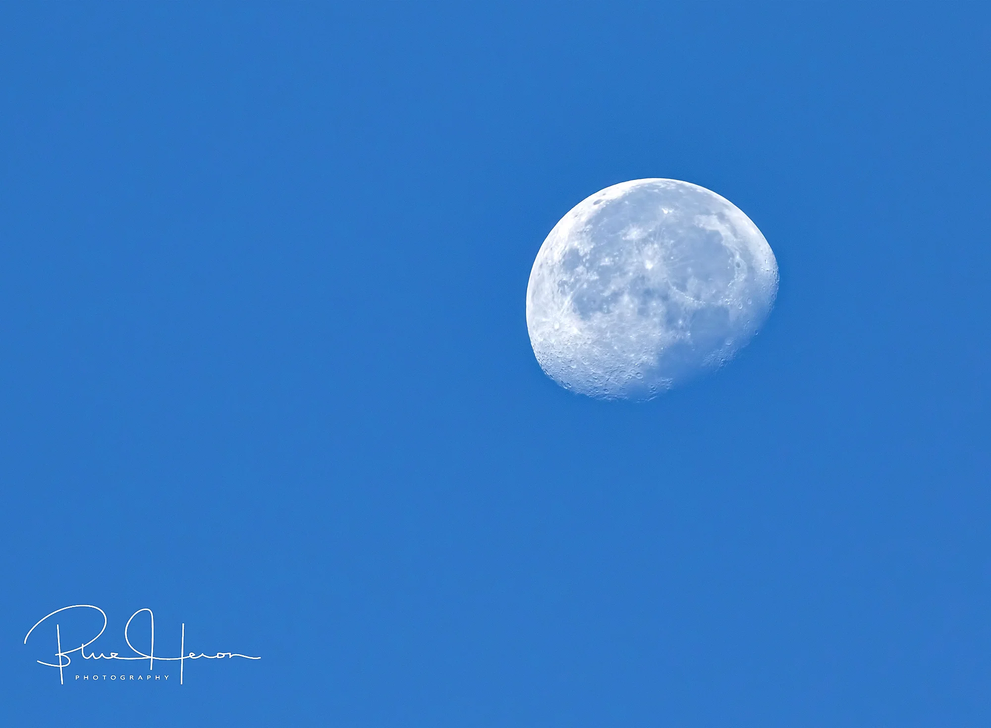 A waning gibbous moon sets in the west..