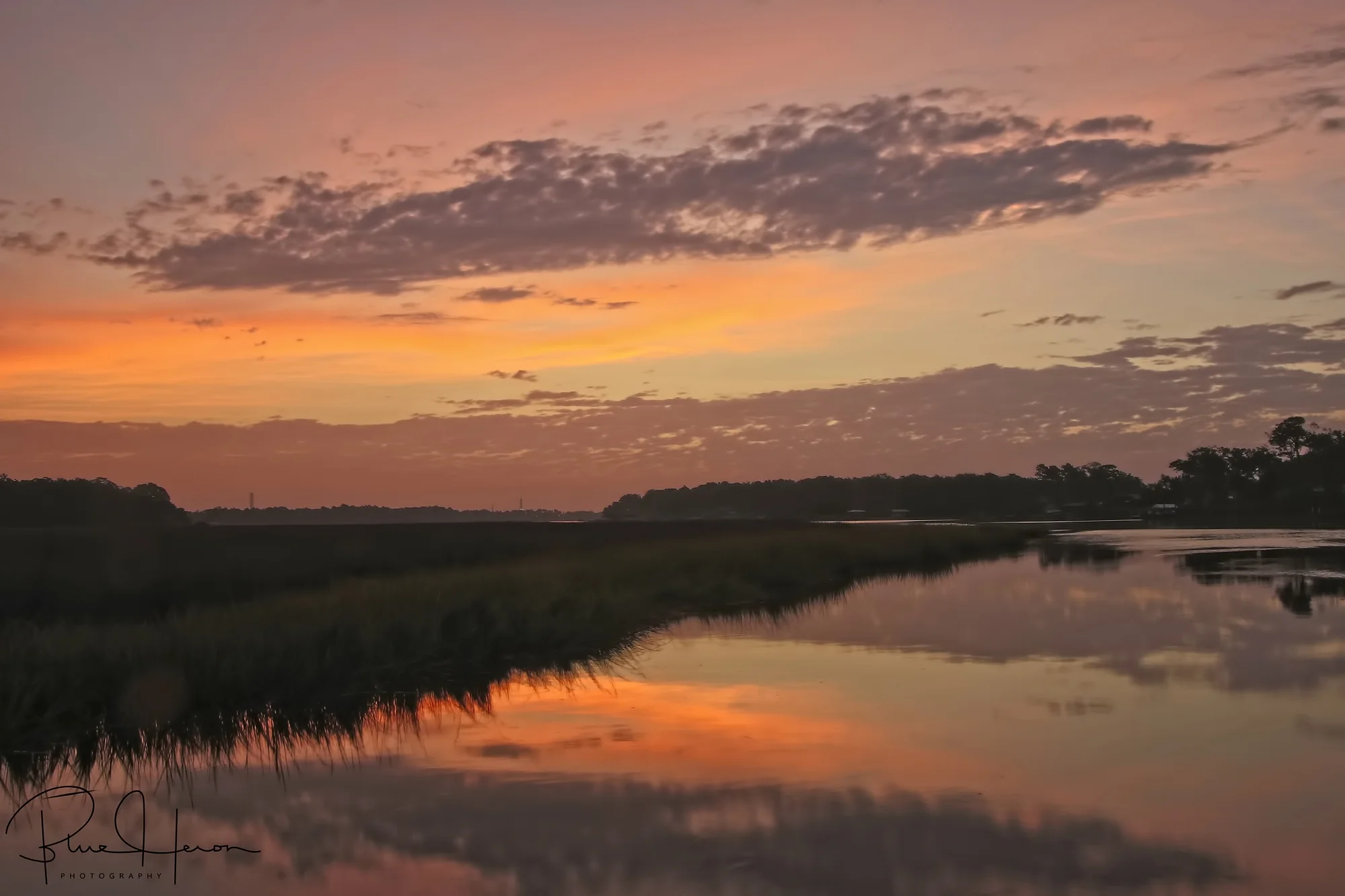 A pink glow appears as the sun struggles to climb.