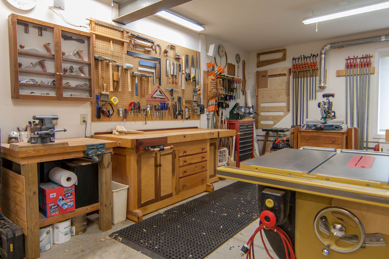 Shop looking NE; workbench 2, North hand plane cabinet, main workbench, tool box, jig and clamp storage, miter saw, table saw