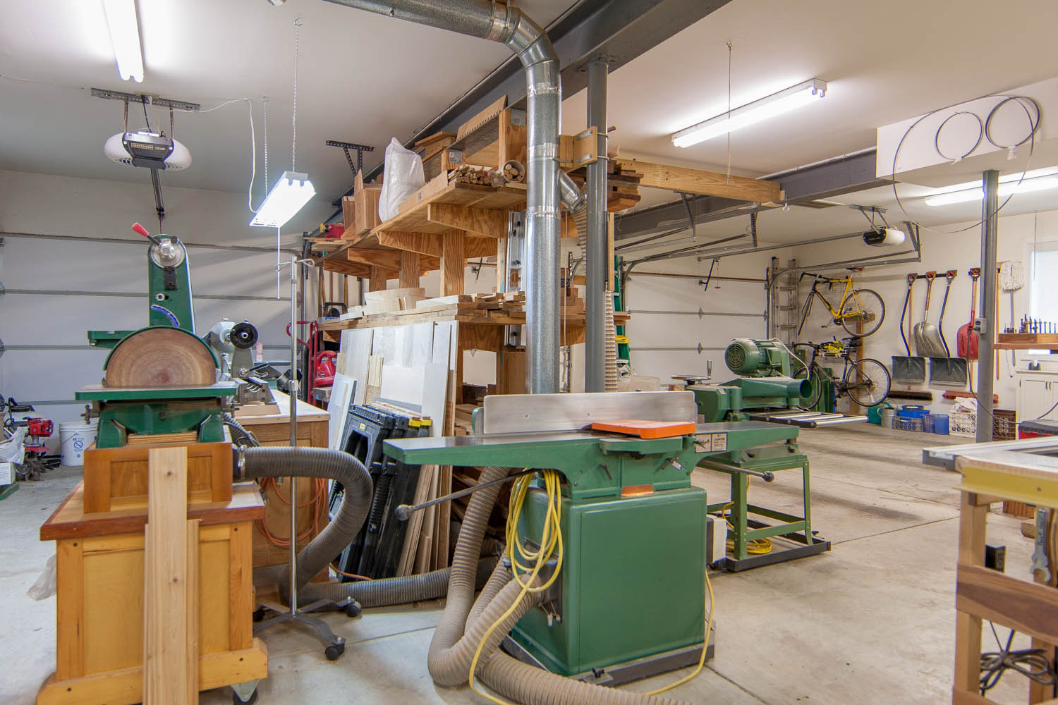 Shop looking SW; from left, disc/belt sander, lathe, lumber racj, jointer