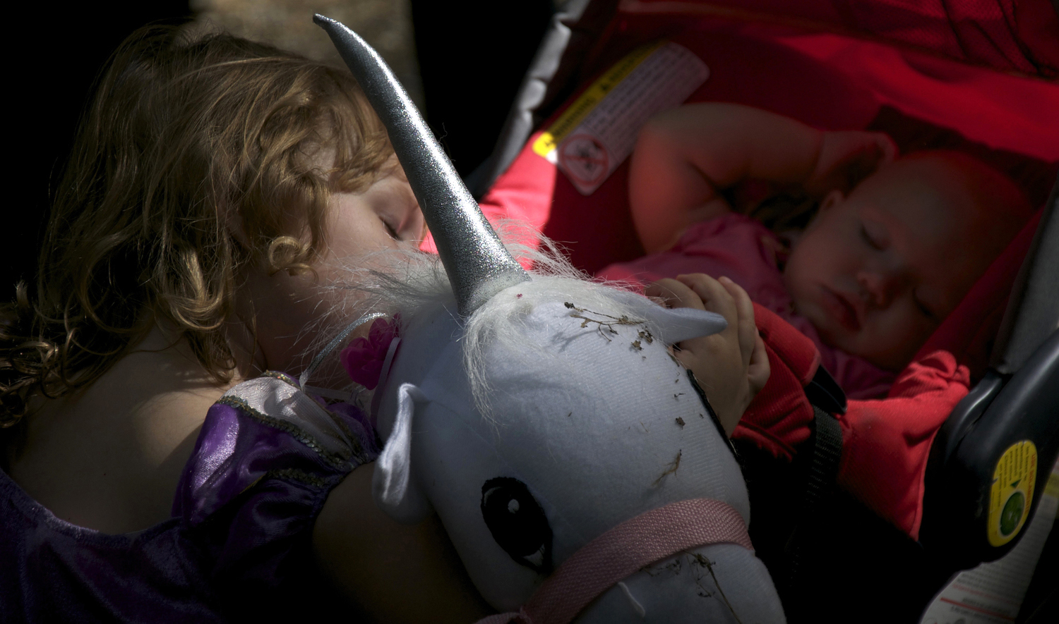  A child and her older sister take a nap during the Maryland Renaissance Festival in Crownsville, Maryland on Saturday, September 15, 2012. 