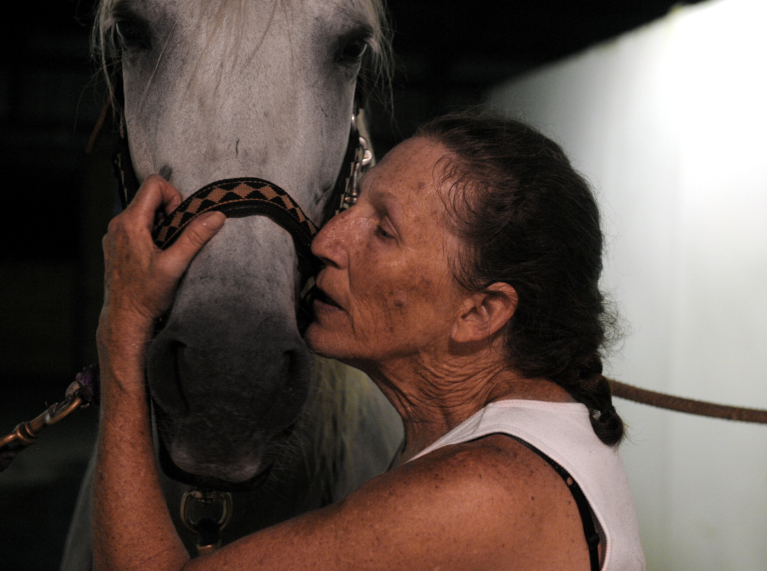 Cecelia Cress of Abingdon kisses and talks to Colada after an evening of riding at Freedom Hills Therapeutic Riding Program in Port Deposit, Maryland on Wednesday, August 17, 2016. Cress, a disabled Air Force veteran, said that horseback riding is helping rebuild her leg muscles after she shattered her knee.