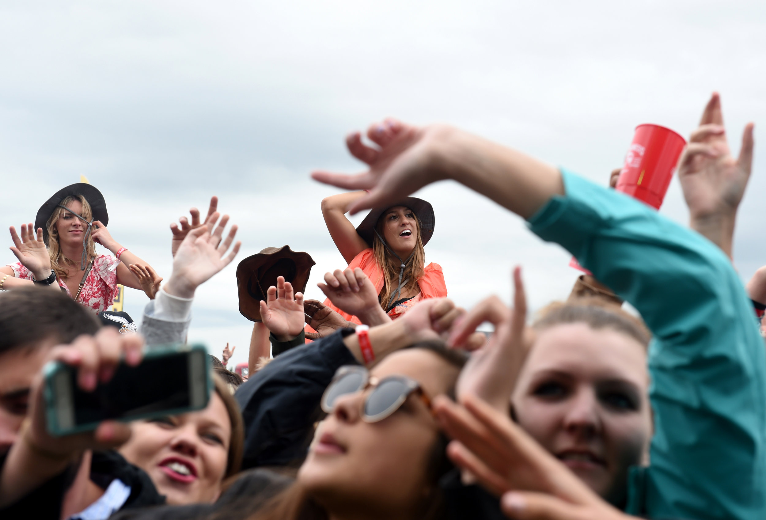  Fans listen as Fetty Wap performs during the Preakness Stakes'&nbsp; InfieldFest &nbsp;Saturday, May 21, 2016 in Baltimore, Maryland. 