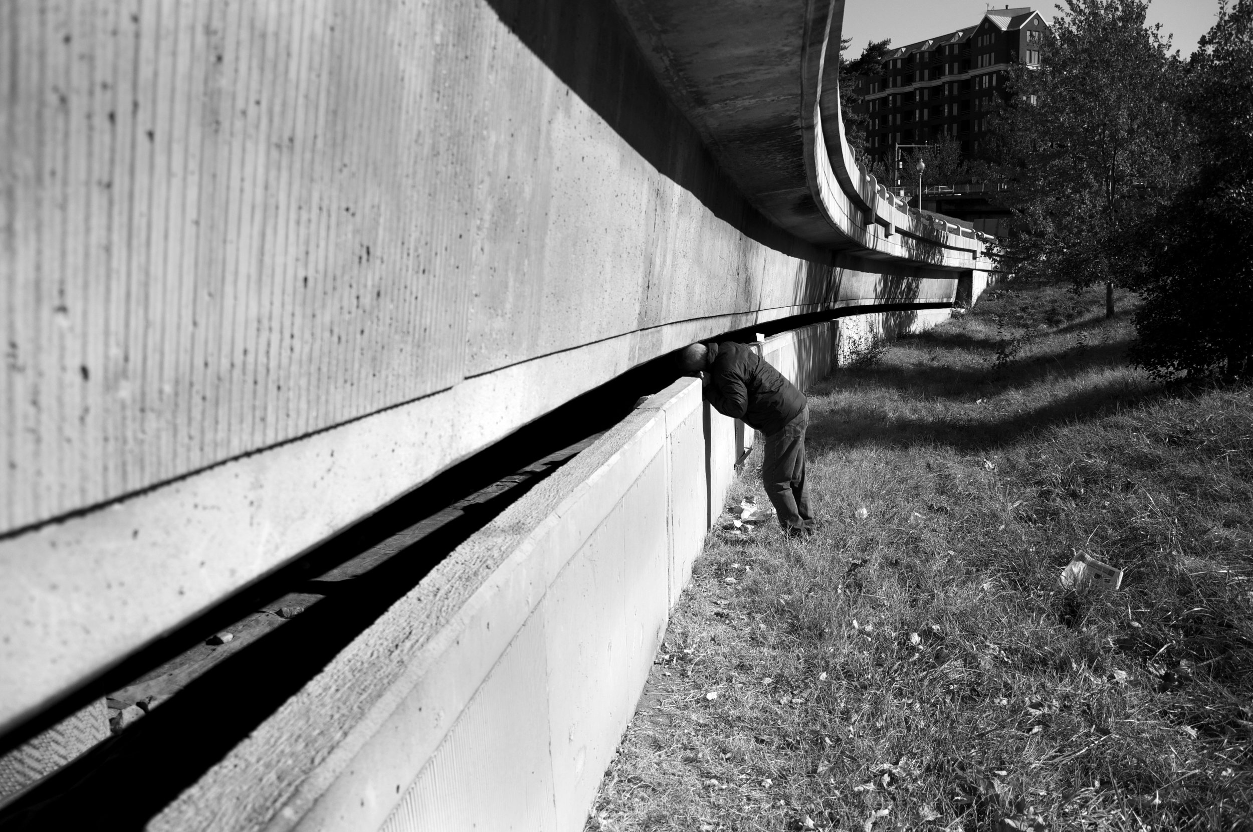  Making his daily rounds, Dr. Anthony Martinez sticks his head into an overpass. Martinez checks on a homeless couple, Cliff and Melanie, who have constructed their own home below Whitehurst Freeway. 