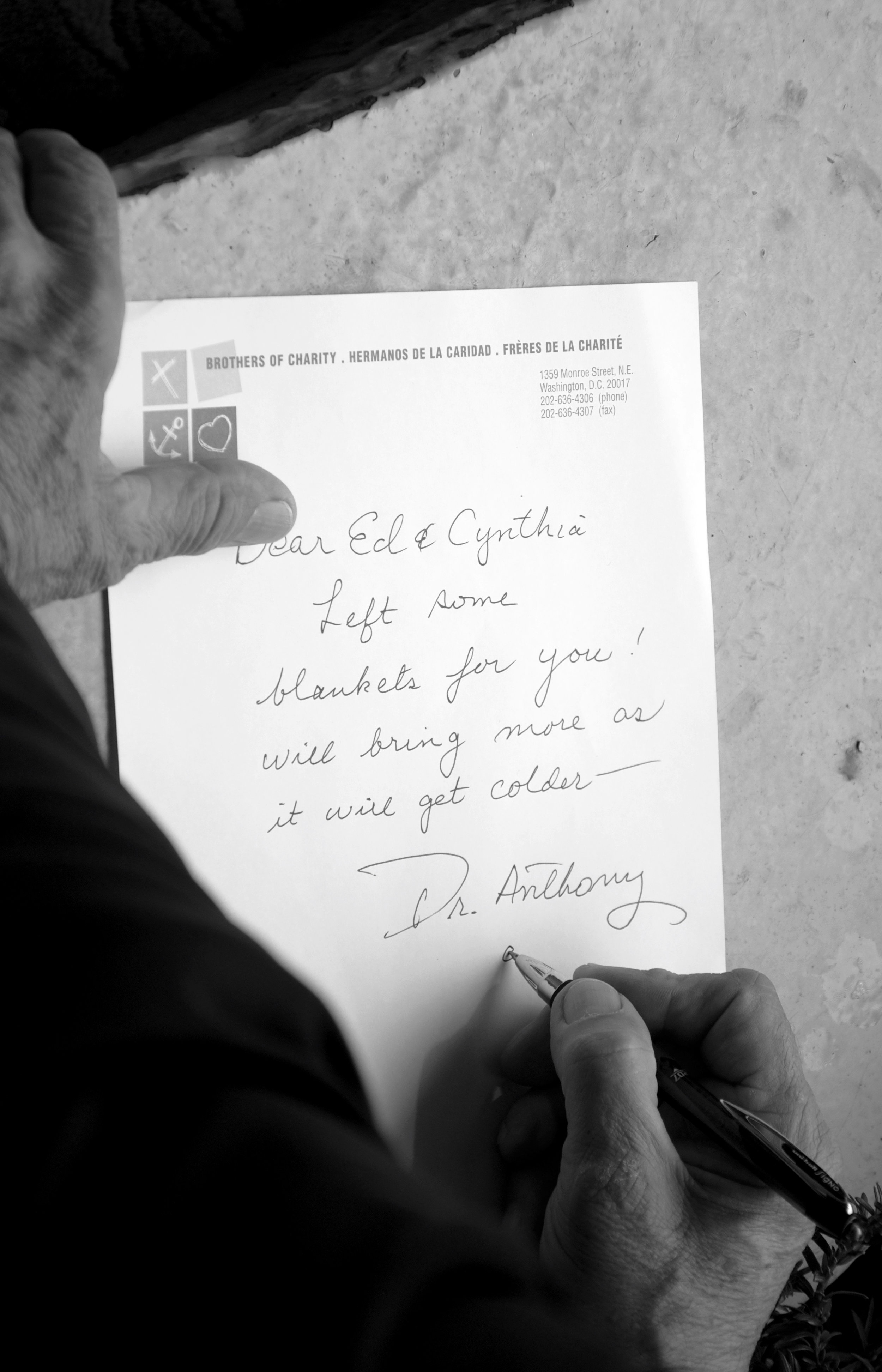  Dr. Anthony Martinez writes a note for Ed and Cynthia, the homeless couple who live outside the Holy Redeemer Catholic School. "Dear Ed &amp; Cynthia," the note says. "Left some blankets for you! Will bring more as it will get colder — Dr. Anthony."