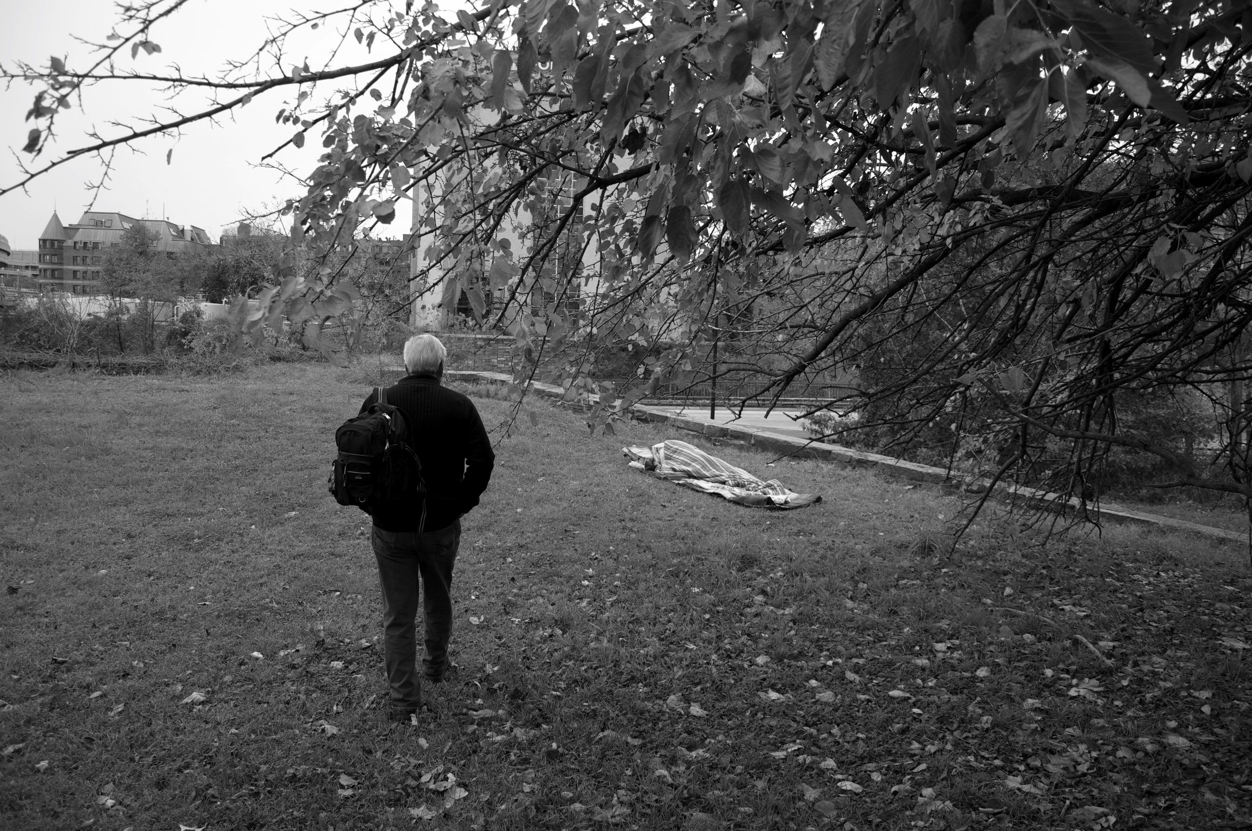  Dr. Anthony Martinez continues his search for homeless people who might need medical assistance. He approaches a sleeping homeless man overlooking Rock Creek Parkway. 