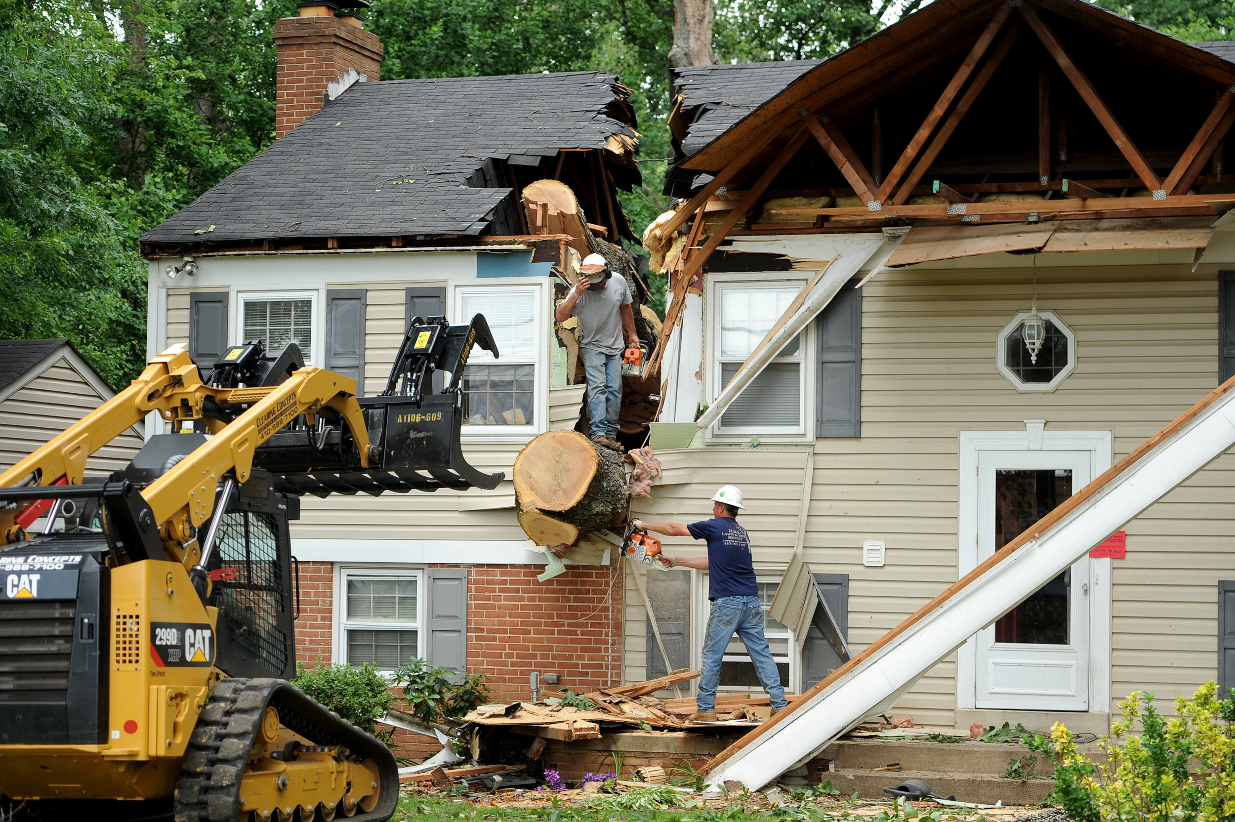  A crew helps clear a tree that fell on a house in Glenelg, Maryland on Wednesday, June 22, 2016,&nbsp;after a tornado touched down in Howard County Tuesday afternoon. 