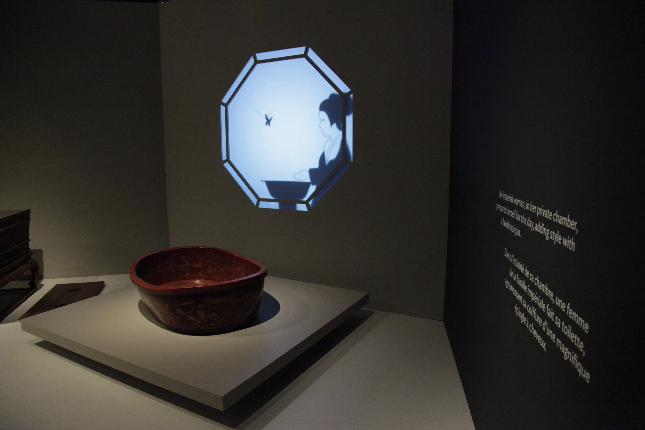   Imperial woman in chamber    An imperial woman, in her private chamber, prepares herself for the day, adding style with a lavish hairpin.  