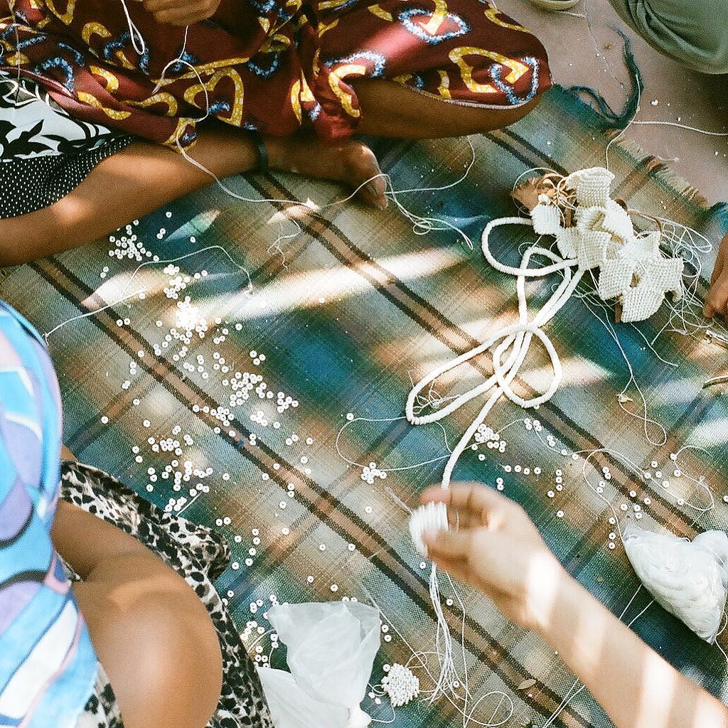 stringing ostrich eggshell beads together
