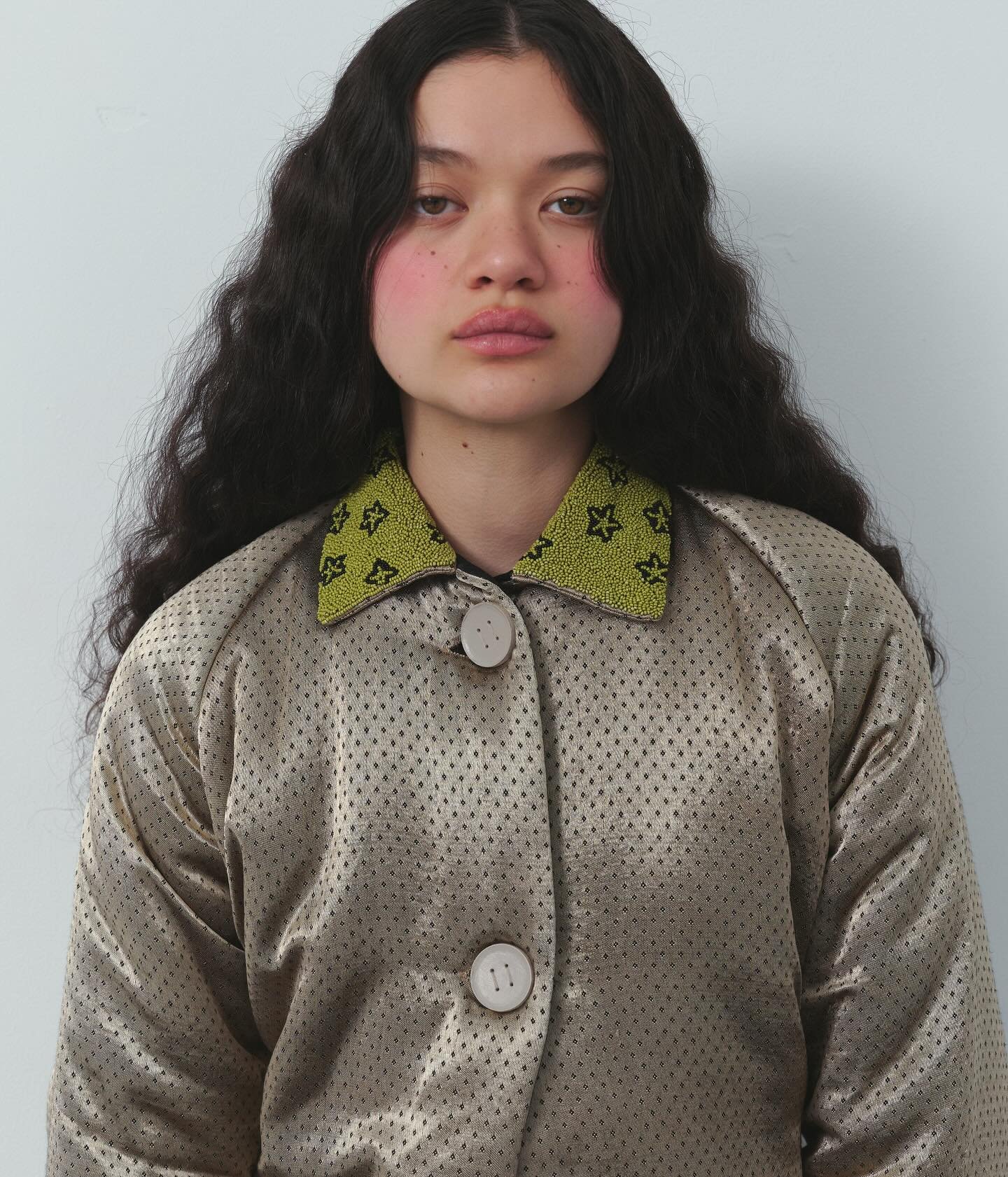 Maddux in hand-woven silk mashroo jacquard puffer jacket with leather buttons and glass beaded collar