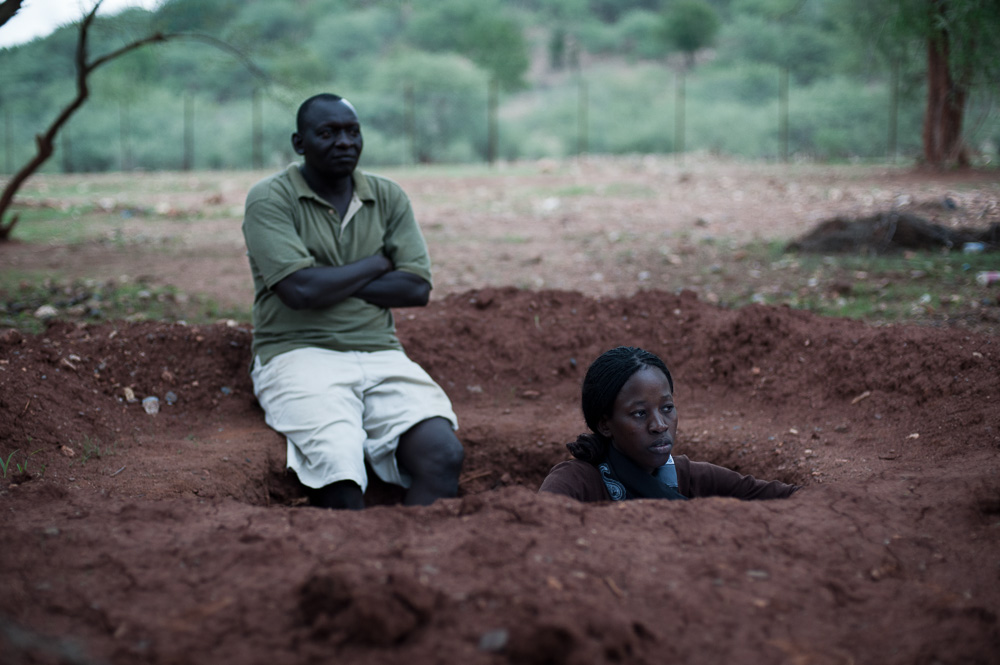 Aid workers shelter from an overhead plane