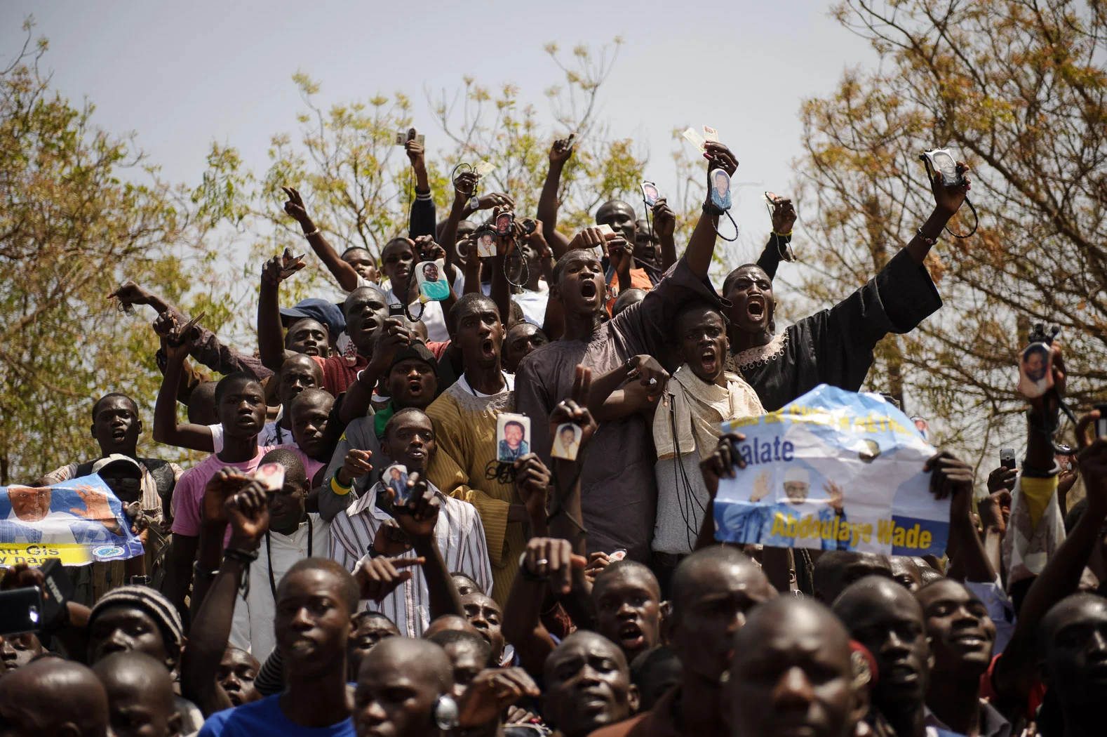 Supporters of President Wade celebrate after he casts his vote in Dakar, Senegal during the 2012 elections that would see him ousted to Macky Sall