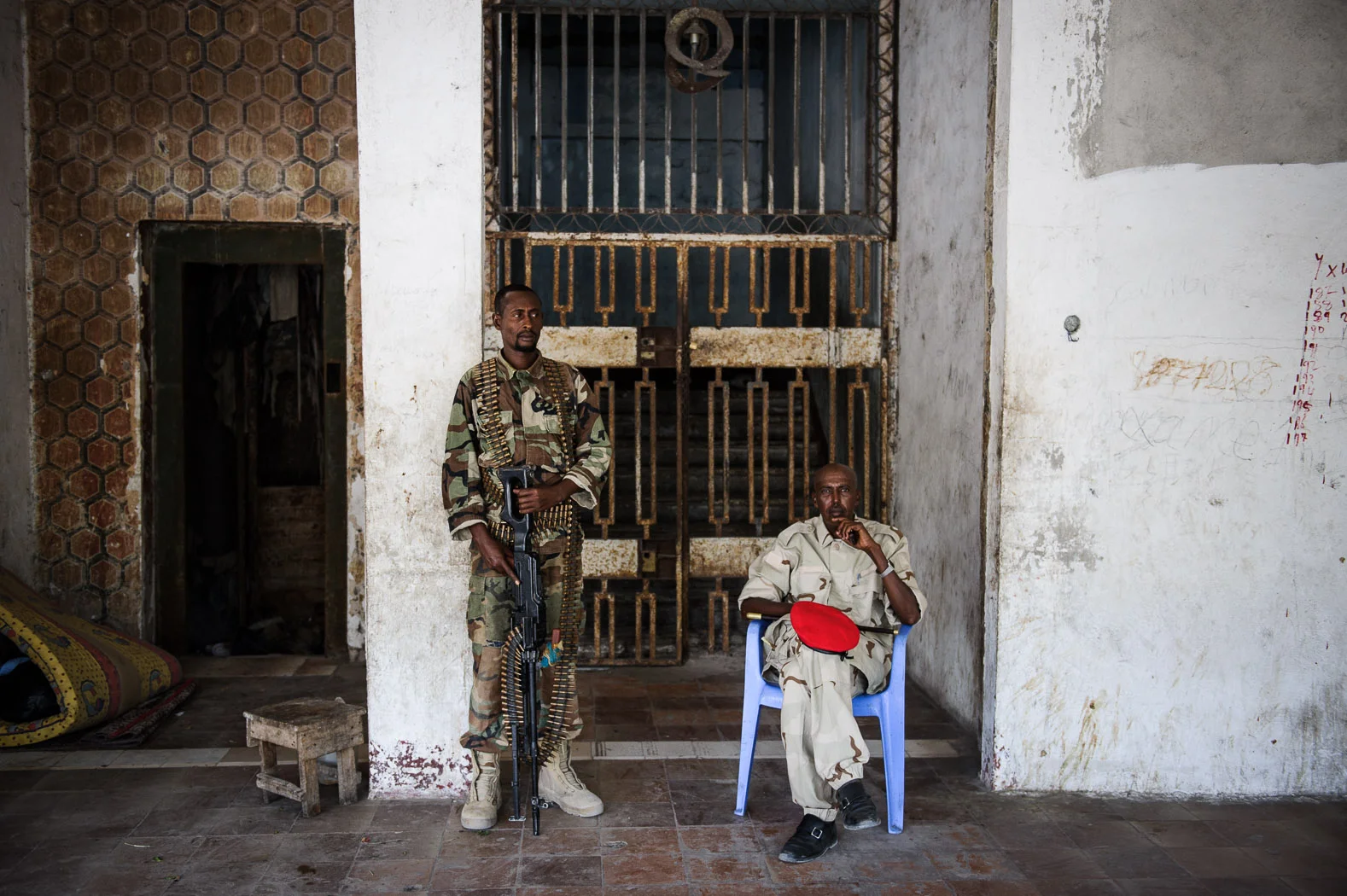 Somali Federal Army soldiers stand sentry outside the National Theatre during a visit by the country's president in Mogadishu, 2012