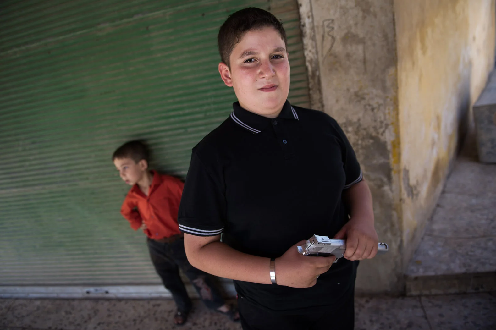 A child celebrates the end of Ramadan with a toy gun in northern Syria