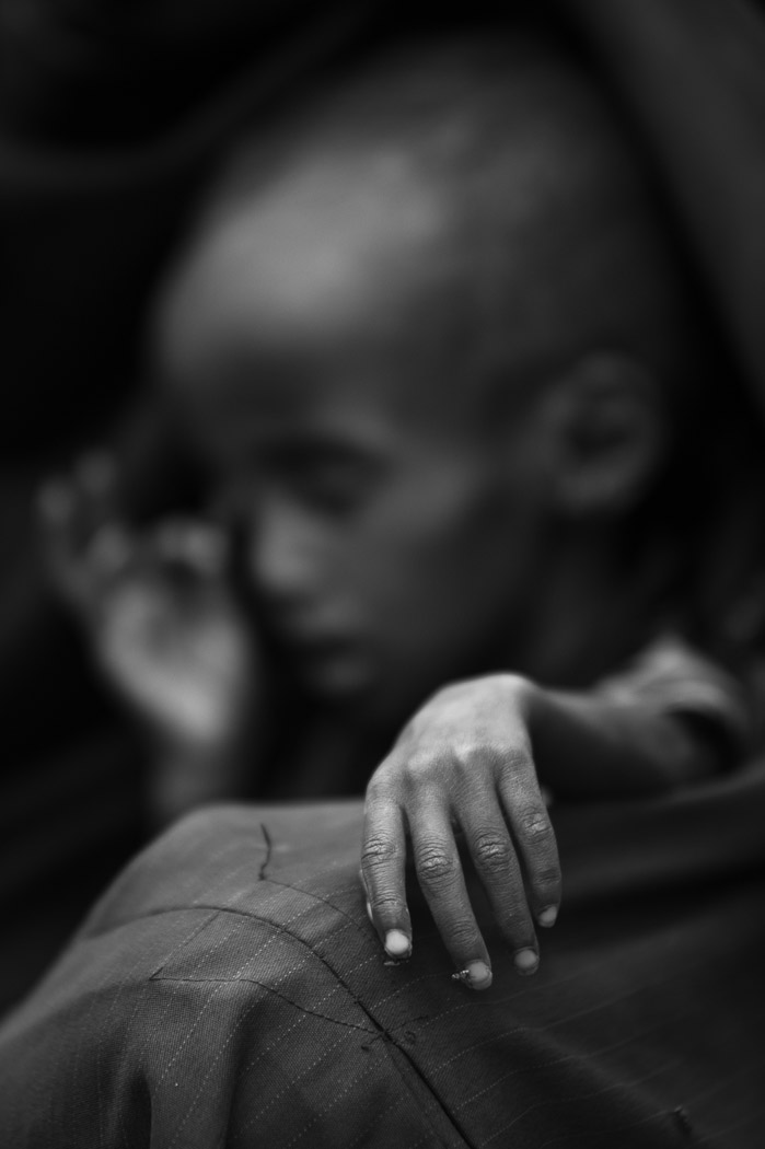 Many Somalis have nothing left. One year old Idman Mohamed, suffering from malnutrition and malaria, sits in his mother's lap at a compound for internally displaced persons in the Somali border town of Dhobley. Idman's parents have left their home and walked for three days to reach Dhobley, in the hope of finding humanitarian assistance. Yet none is here. They say they have no money to buy any medicine for their son, and so intend to cross the border into Kenya.