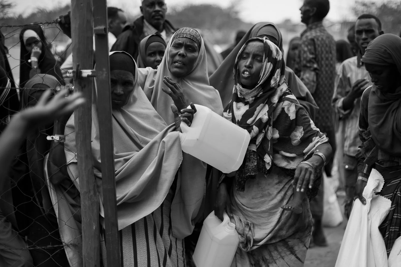 Somali women try to get access to water at the reception centre in Ifo camp. Having passed through the reception centre, refugees must wait to become registered in order to receive their ration-card and to officially assume the status of refugees. With so many new arrivals, however, there is currently a backlog of around two months, meaning that many people are without food once their initial ten-day ration has been consumed.