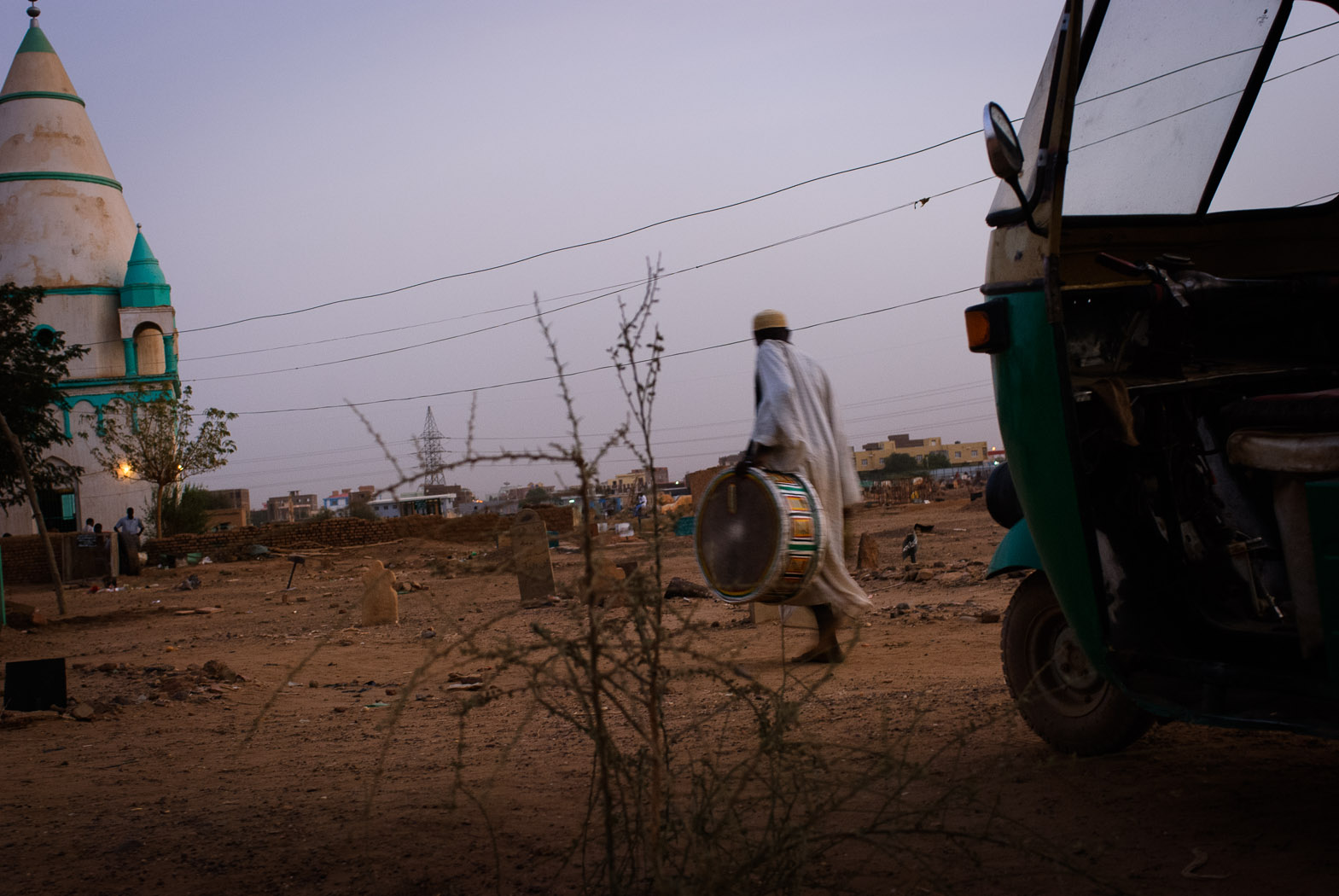 A Sudanese sufi walks with a drum to the Hamid el-Nil mosque in Omdurman.