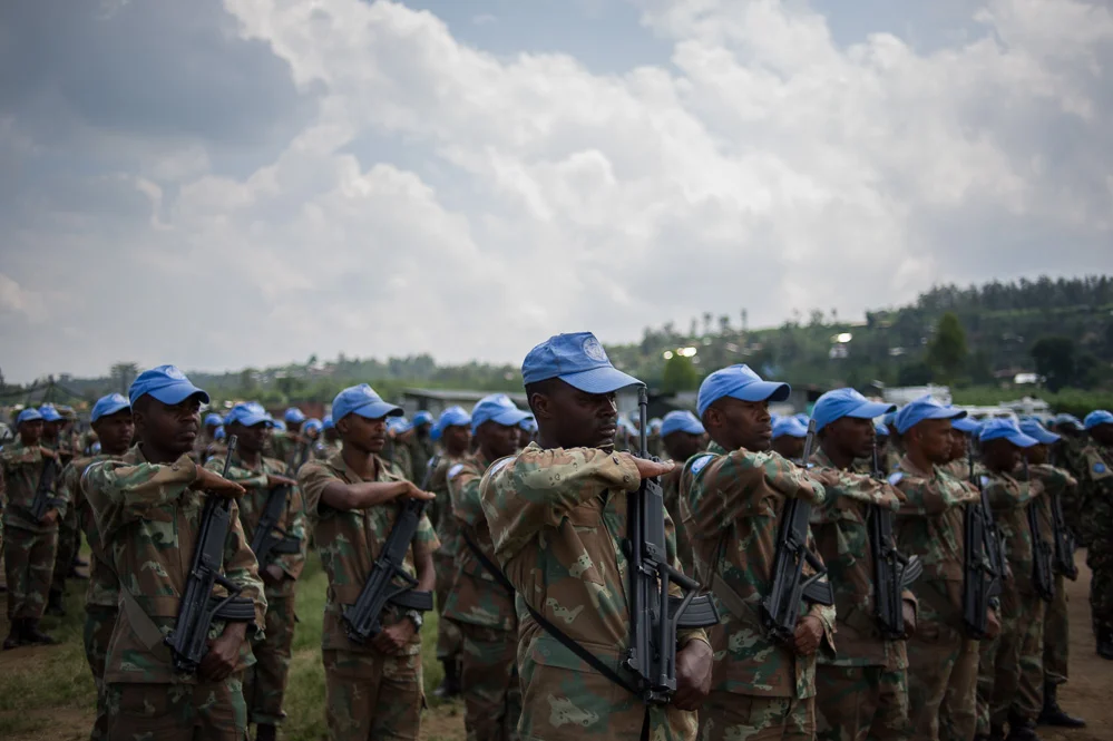 UN troops during a ceremony for a Tanzanian peacekeeper killed during the operation to recapture Kiwanja
