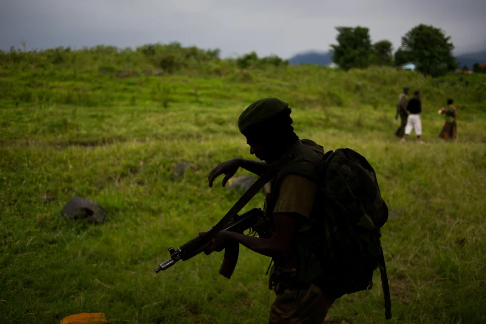 FARDC soldier walks through the recaptured Rumangabo military academy
