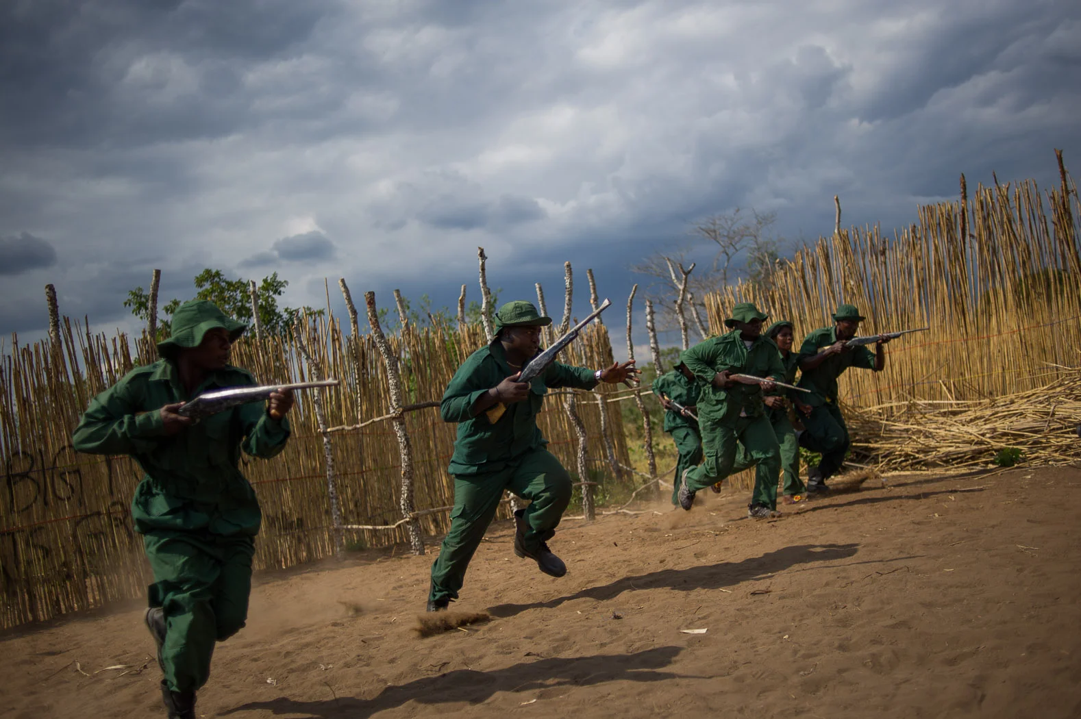 The "Big Power Arts Group", acting as Wildlife Rangers, charge during a reenactment of a film they are producing, entitled "Who is to blame?" The film explores the illegal poaching of animals stemming from Mloka, a village notorious for elephant poaching.