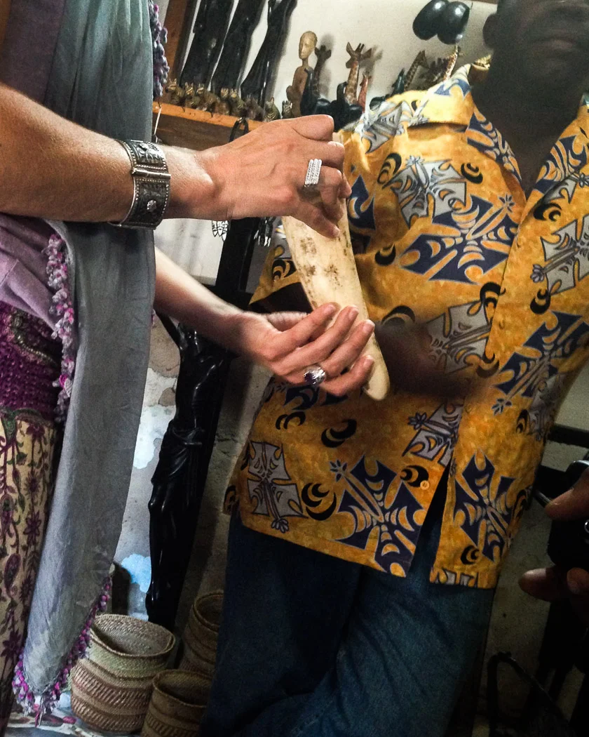 A journalist holds a piece of ivory in a small curio shop for tourists in the Mwenge Market. The owner of the shop produced the end of one elephant's tusk, weighing around 1-1.5kg which he was prepared to sell for 400,000 Tanzanian Shillings (approx. 200 Euros) and said that he could get more.