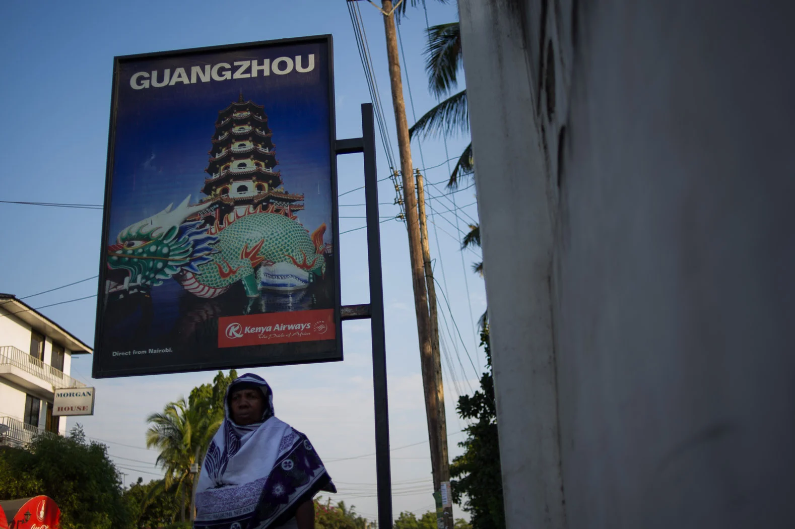 An advertisement for flights to Guangzhou by Kenya Airways stands in the streets of Dar es-Salaam. Guangzhou is China’s main ivory-carving-and-trading center.