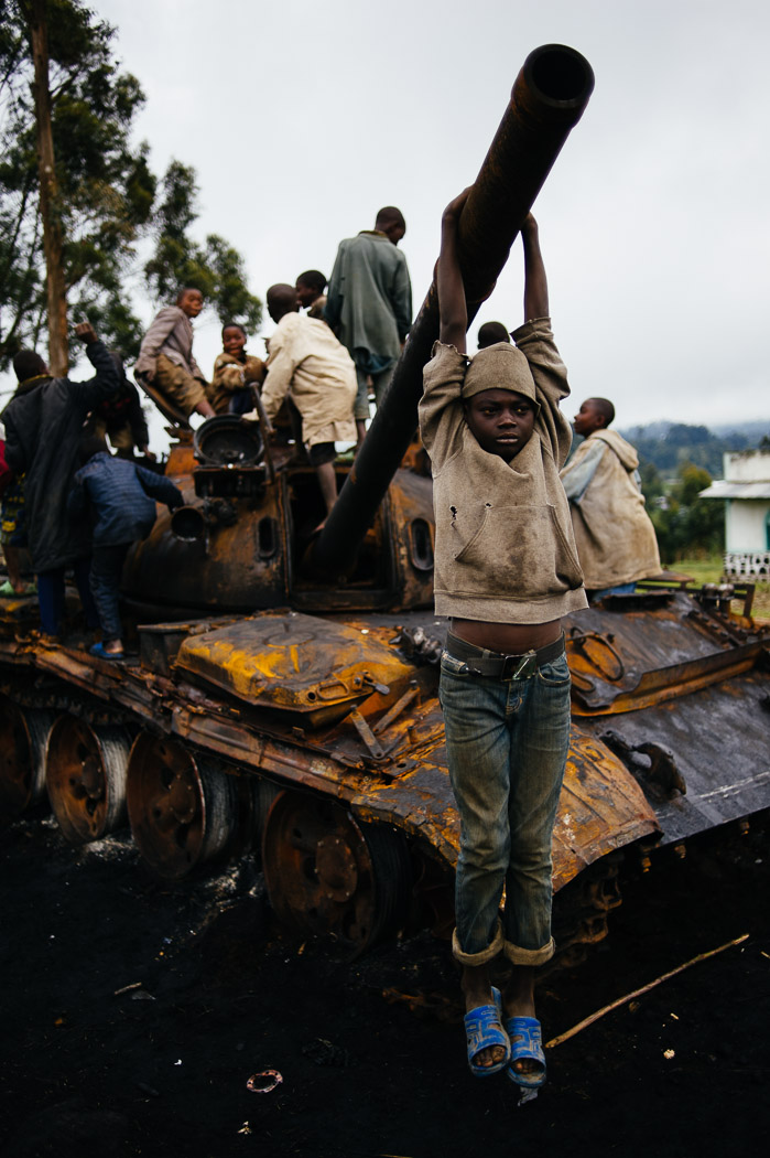 Congolese children play on a destroyed tank used by M23 forces in Kibumba. Children here have grown up with conflict, and this marks an end of just one of myriad armed groups operating in the region.