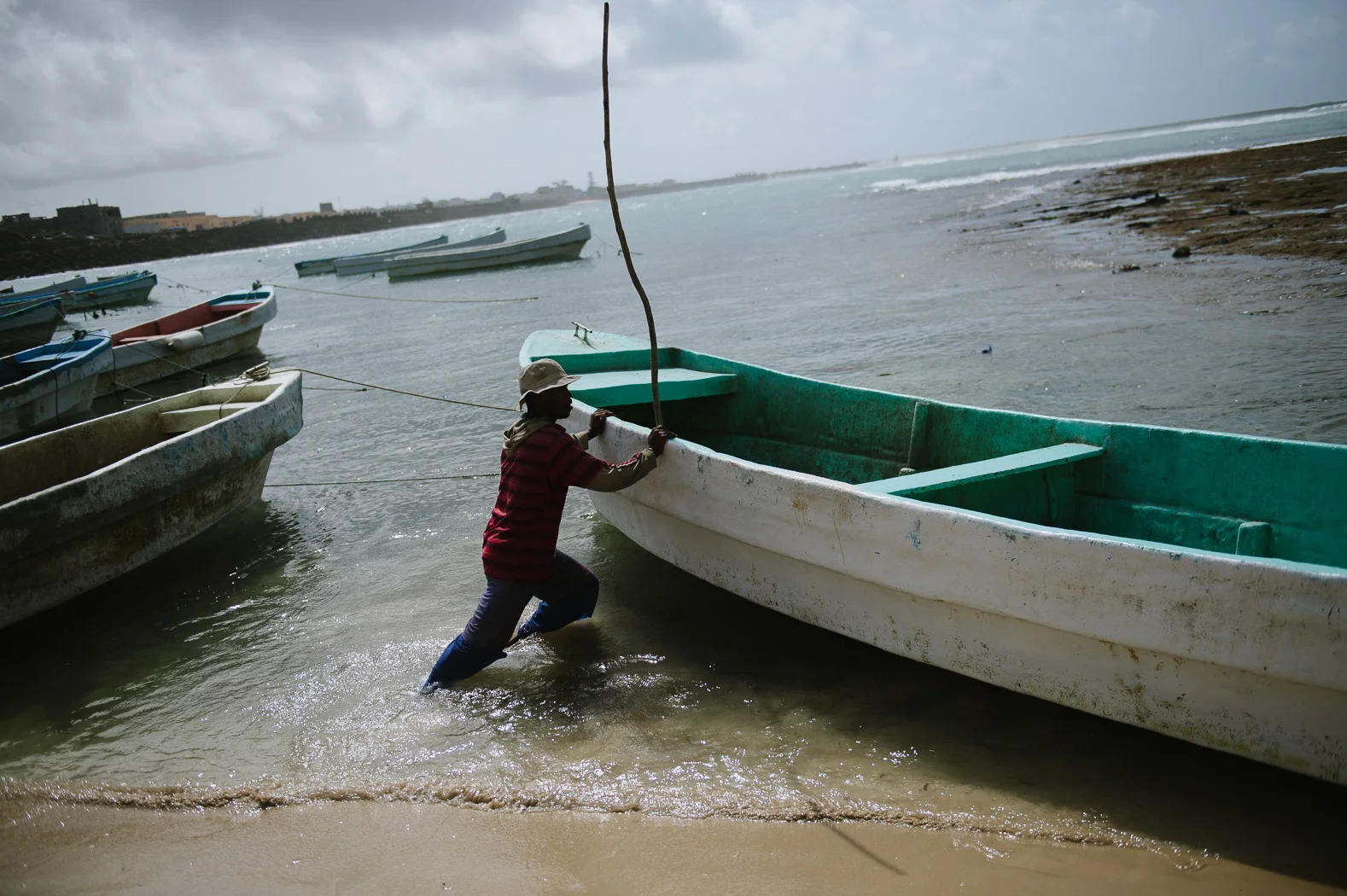 A man prepares a boat in the old harbour