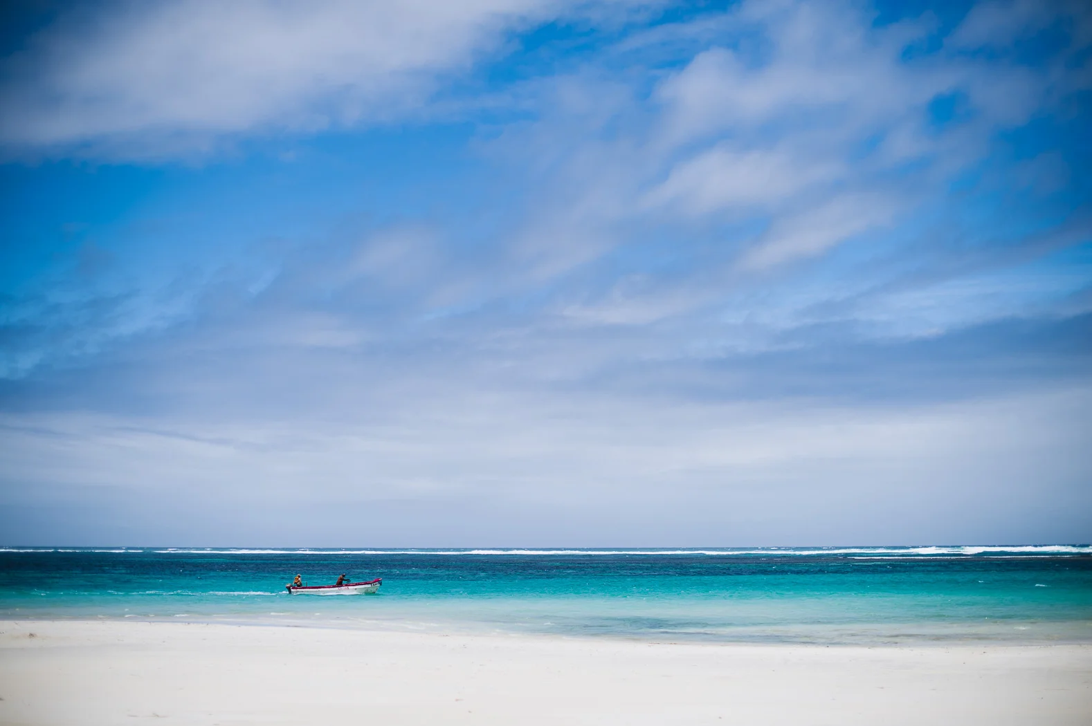 A boat passes along the white sands of the Lido beach in Mogadishu.