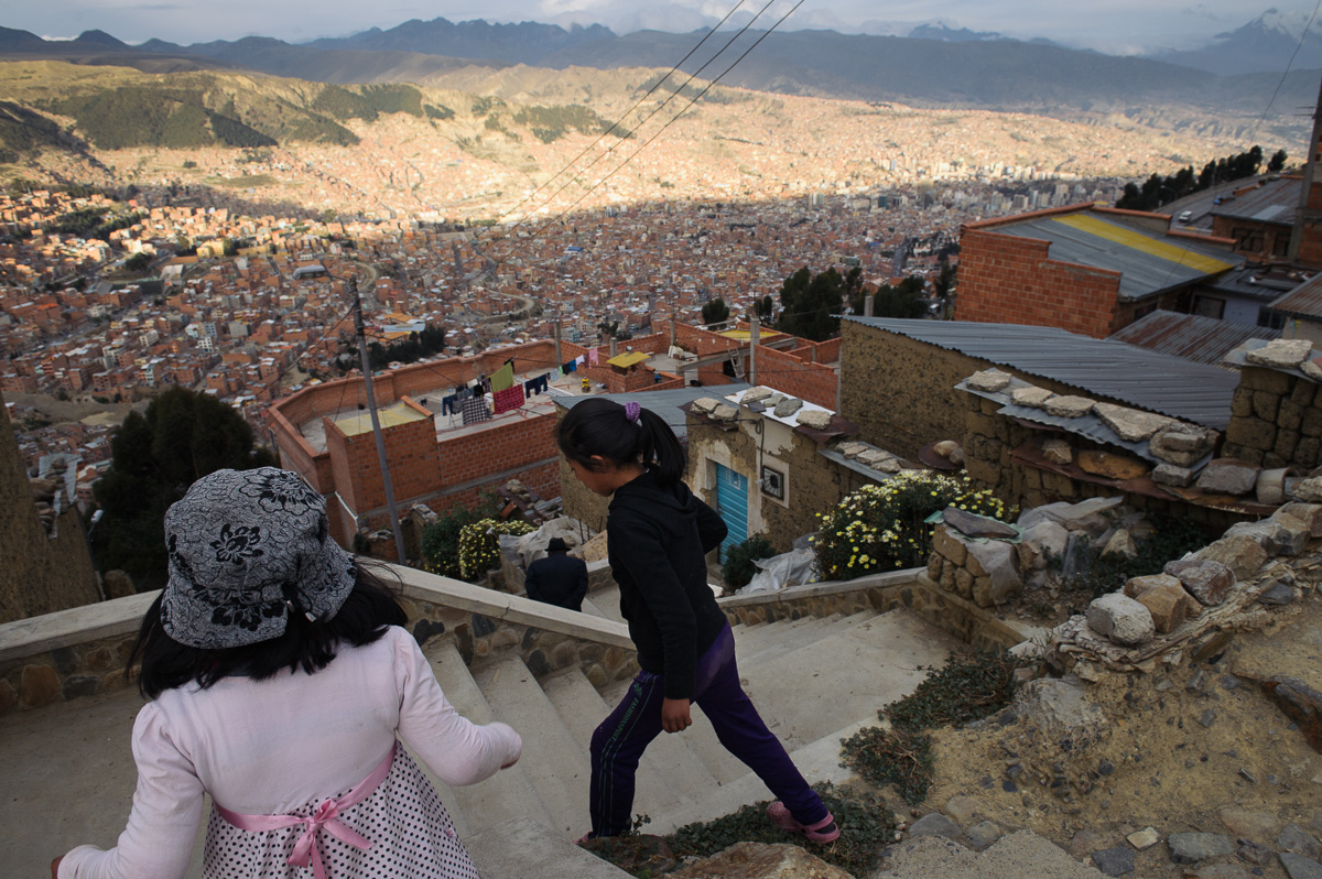 Young girls walk through a poor neighbourhood in the city of El Alto, overlooking the Bolivian capital of La Paz.