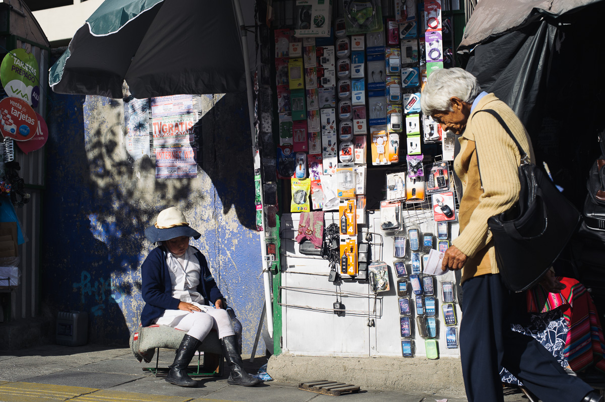 A young girl works on a street-side stall selling mobile-phone accessories in La Paz, Bolivia.