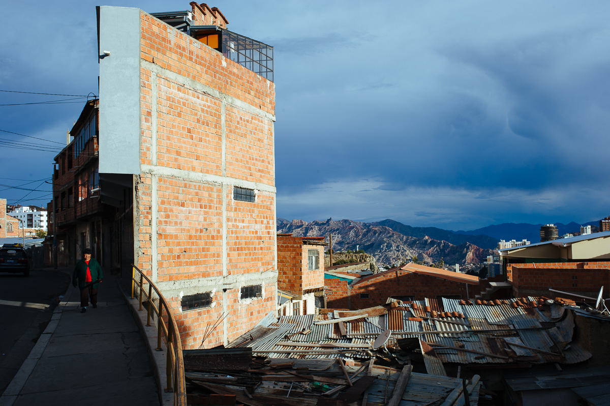 A lady walks down a street in a poor area of La Paz, Bolivia.
