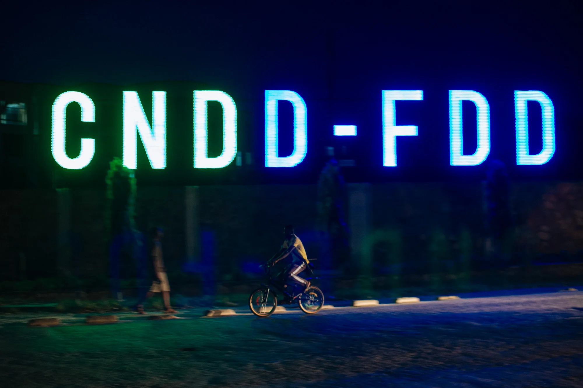 A cyclist passes the headquarters of the ruling CNDD-FDD party in Bujumbura, Burundi, on May 9, 2015. Burundi's government on Saturday ordered "insurgents" to end weeks of demonstrations against President Pierre Nkurunziza's third term bid and ordered all barricades to be removed within 48 hours.