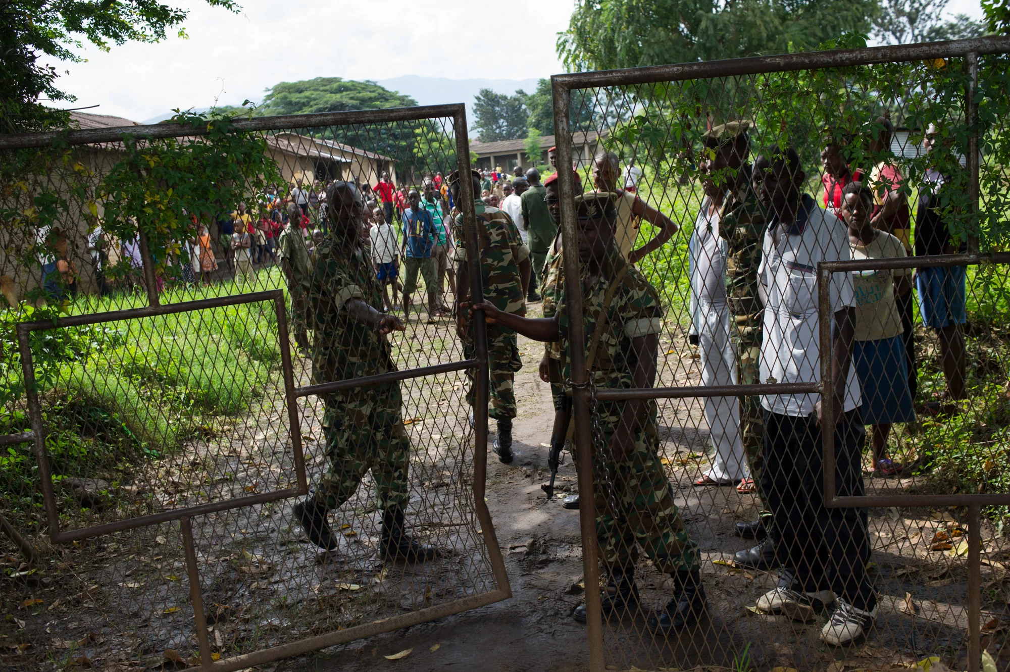 Army soldiers close the gate to the Ngagare military camp after taking a man accused of being an Imbonerakure, a member of the ruling CNDD-FDD party's youth wing, in Bujumbura, Burundi, on May 9, 2015. Witnesses say that the man was beaten and then handed over to the army. 