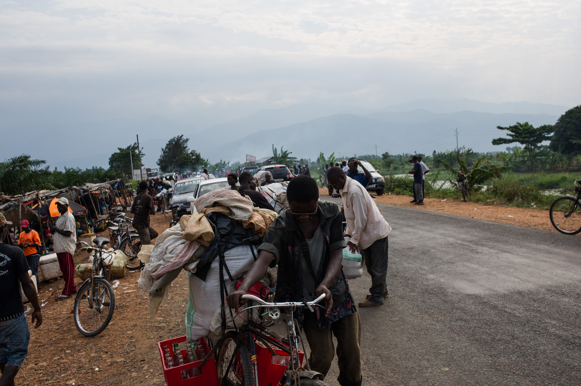 People transport goods at the border with D. R. Congo at the Gatumba border crossing in Burundi on June 20, 2015. Due to increased insecurity cross-border trade has been affected.