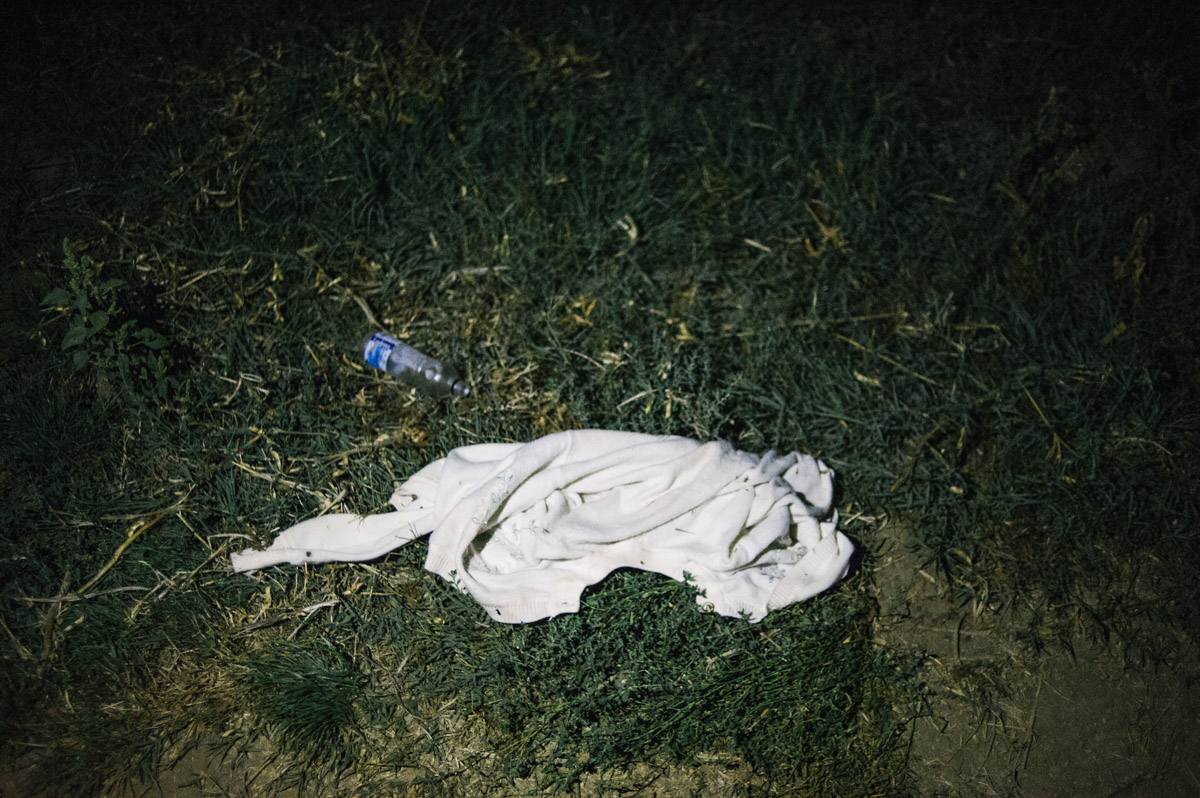 A cardiagan is left by the side of a track in the fields between the Serbian and Croatian border, pictured during the night of September 17, 2015, near Tovarnik, Croatia.