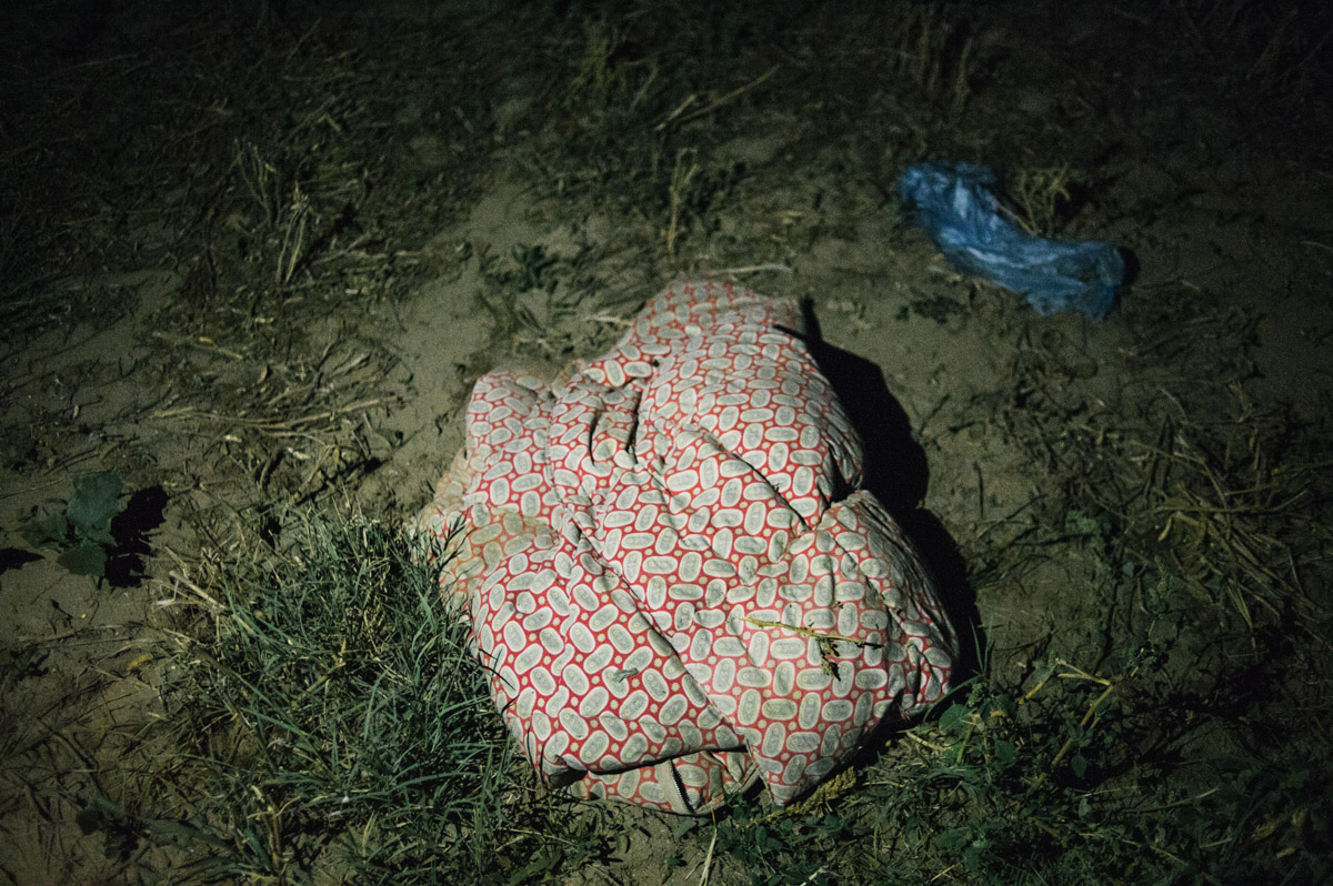 A blanket is left by the side of a track in the fields between the Serbian and Croatian border, pictured during the night of September 17, 2015, near Tovarnik, Croatia.