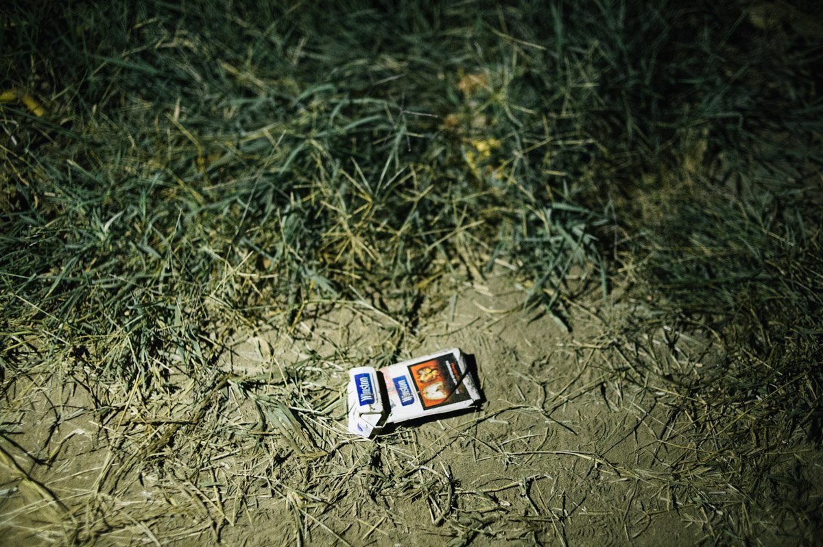 A discarded cigarette packet is left by the side of a track in the fields between the Serbian and Croatian border, pictured during the night of September 17, 2015, near Tovarnik, Croatia.