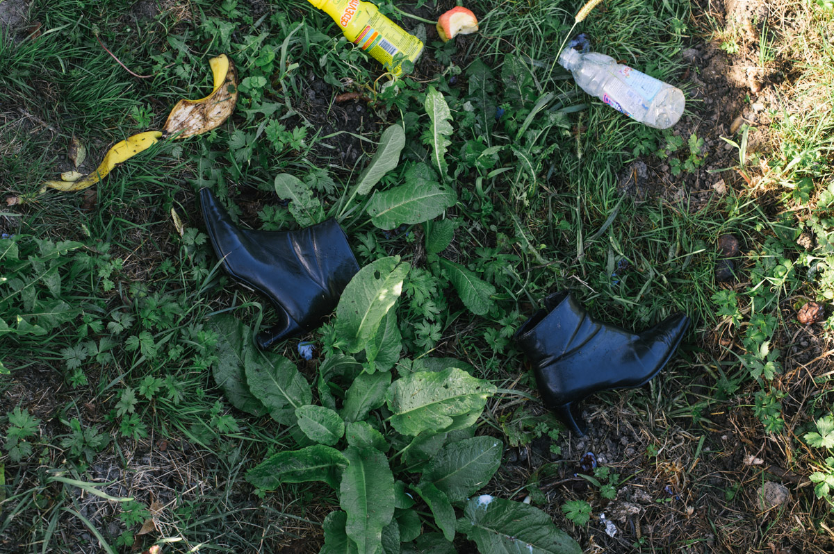 A pair of ladies boots lay on the ground by the roadside in the Croatian town of Tovarnik, on September 18, 2015. Thousands of migrants and refugees had arrived in Tovarnik, waiting sometimes for days at the station, hoping to get on a bus or train onto northern Europe.