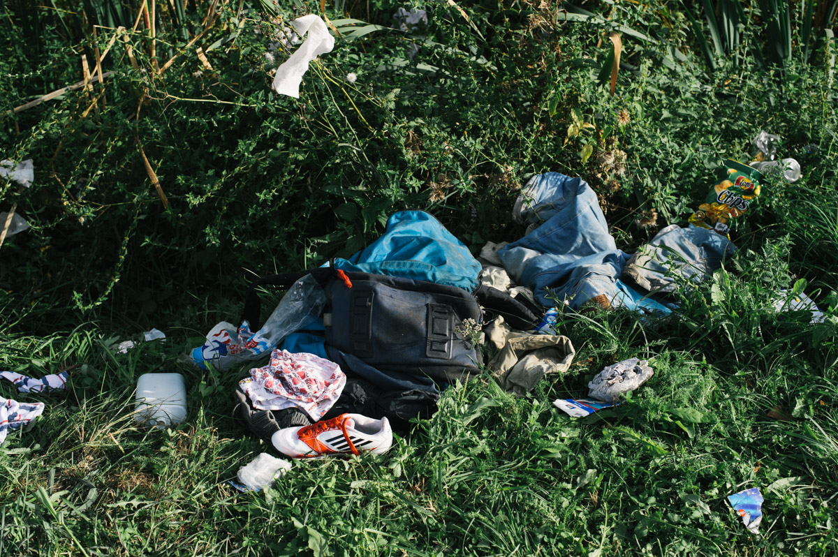 Clothes, shoes, and a bag lay discarded in a bush by the roadside leading to the station in the town of Tovarnik, in eastern Croatia, on September 19, 2015. Having crossed into Croatia from Serbia, and being kept in the town of Tovarnik, people were put on buses and brought up to the town of Beli Manastir and on to the border, where Hungary would bus them through to Austria.