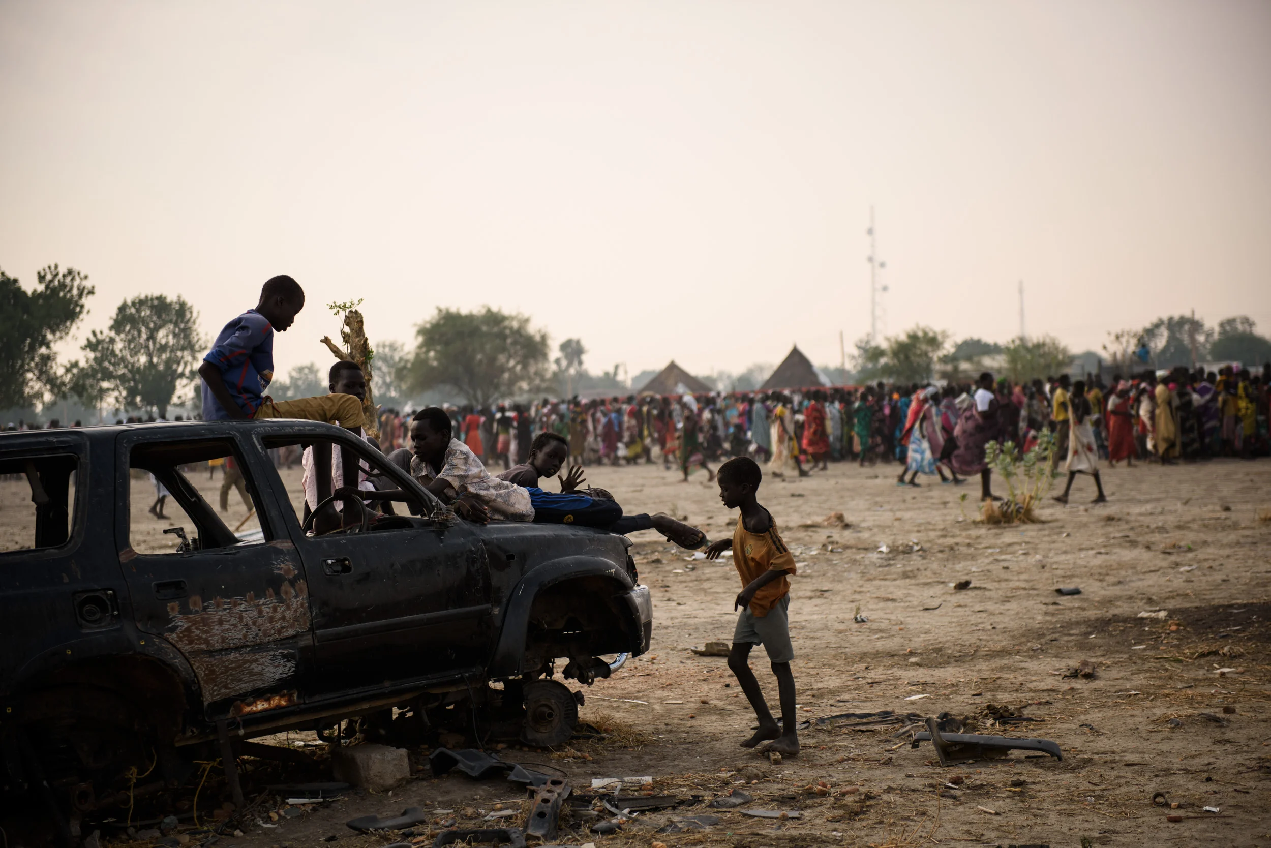 Children play on the shell of a car abandoned during fighting in the town of Bentiu, South Sudan, on May 4, 2017.