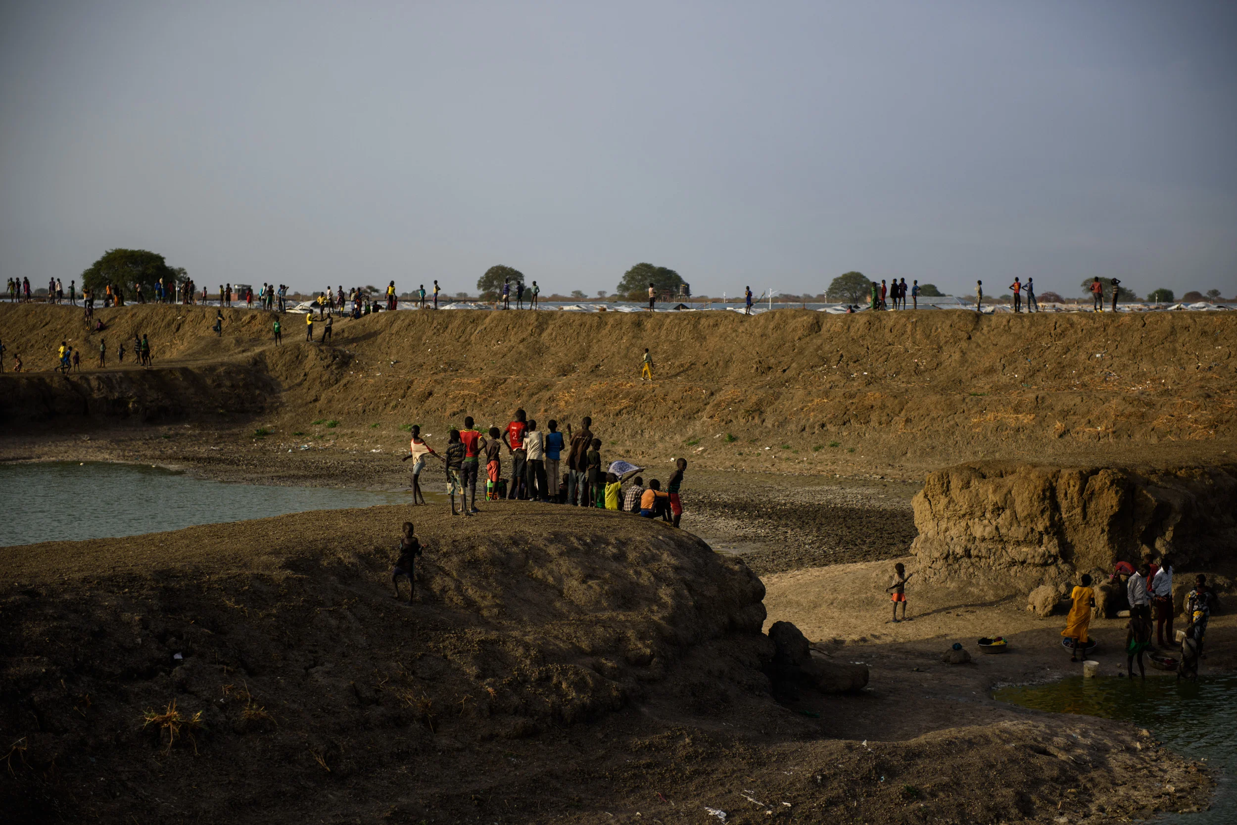 Children stand above an artificial lake in the middle of the Protection of Civilians (PoC) site in Bentiu, South Sudan, on April 28, 2017.
Photo by Phil Hatcher-Moore - UNICEF