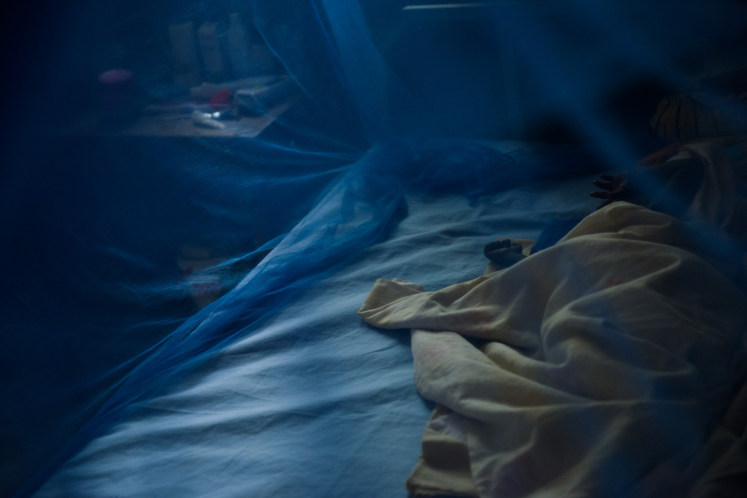 Bida Isaac (9 months) lays under a mosquito net in the stabilisation ward of the Yei hospital in Yei, South Sudan, on April 26, 2017. Isaac was admitted one month previously with severe acute malnutrition, as well as pneumonia and malaria, and was f