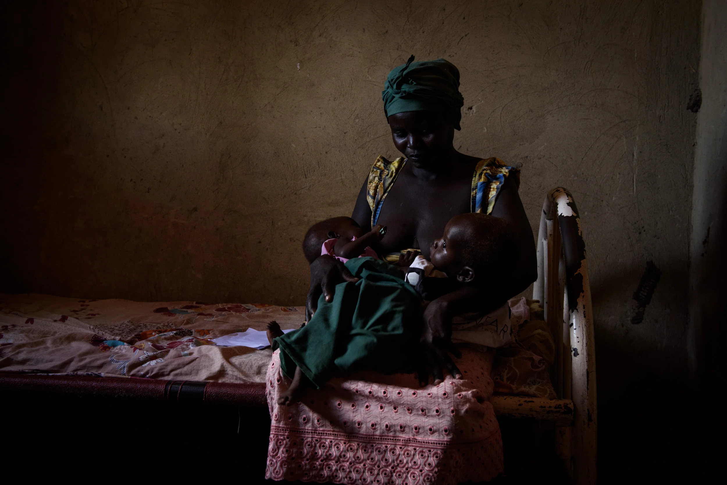Jayna Jama sits with her one year old twins, Beterian Kiko (left) and Bismak Lem (right), during a consultation at the Lomoko Static Clinic in Yei, South Sudan, on April 26, 2017. Jayna's husband was shot by soldiers whilst making charcoal in December last year, and her twins are suffering from malnutrition, and Beterian has also contracted malaria. They were refrerred to the clinic by community mobilisers.
Photo by Phil Hatcher-Moore - UNICEF