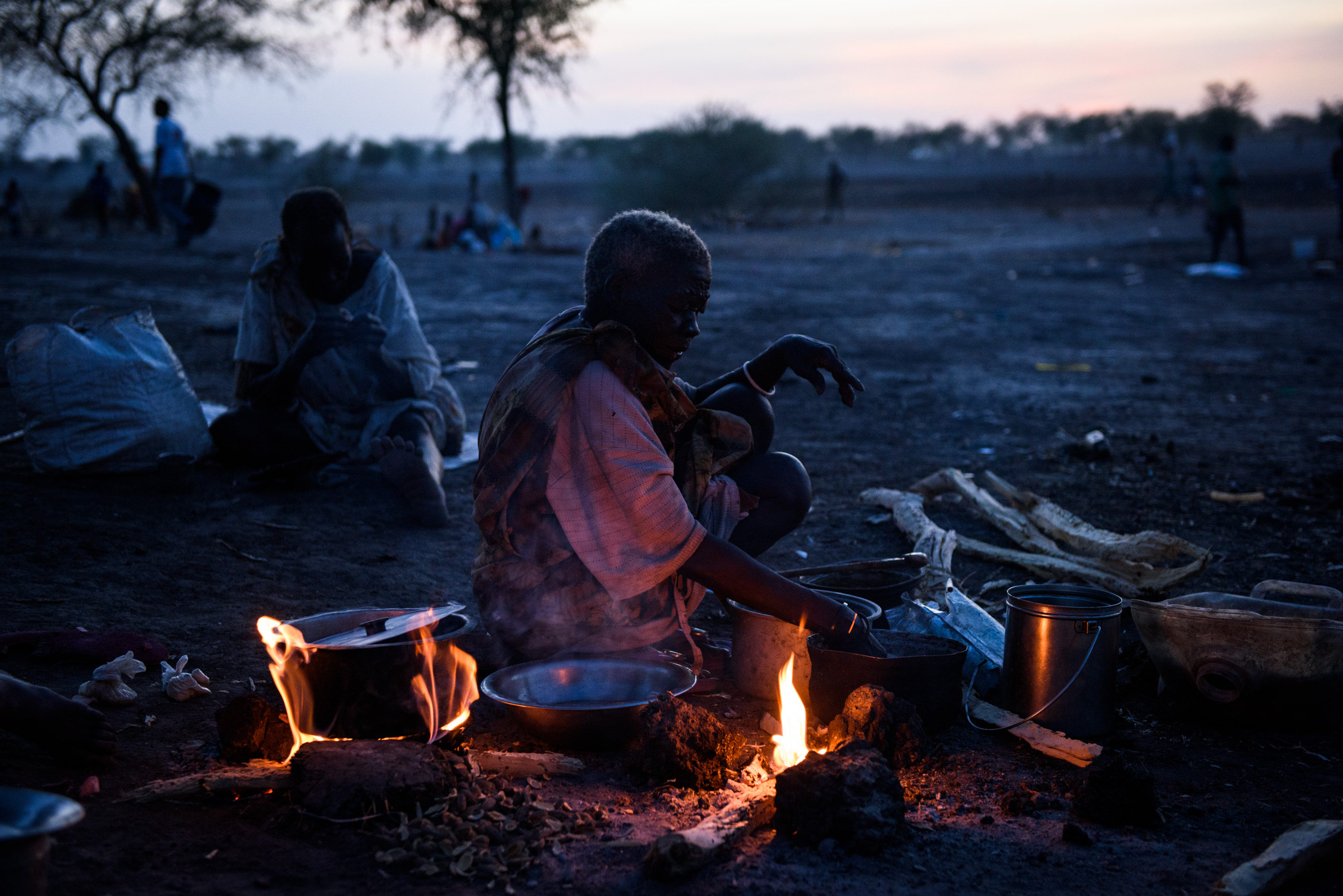An elderly lady cooks on a camp fire where she lives under a tree in the village of Aburoc, South Sudan, on May 10, 2017. Tens of thousands have fled further north to camps in neighbouring Sudan, as government forces advance, but for many people, th